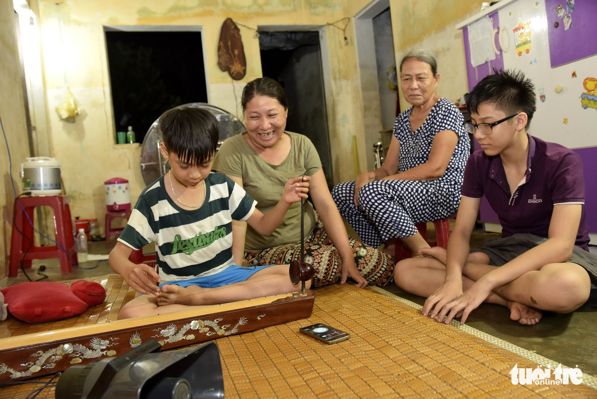 In Vietnam, elderly woman, daughter peddle to support grandson’s pursuit of traditional music