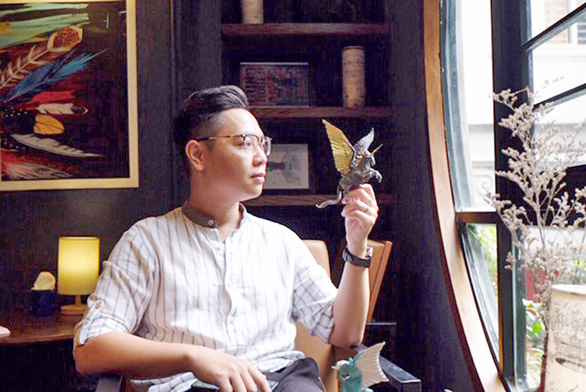 Young Vietnamese man infatuated with Origami