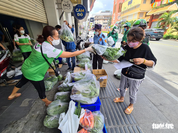 As locals scour markets for veggies, Saigon drugstores sell groceries on sidewalks