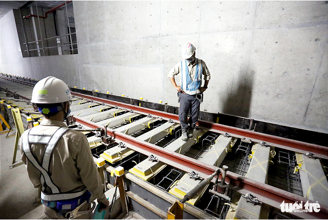 Construction workers install final rail section on Ho Chi Minh City’s first metro route