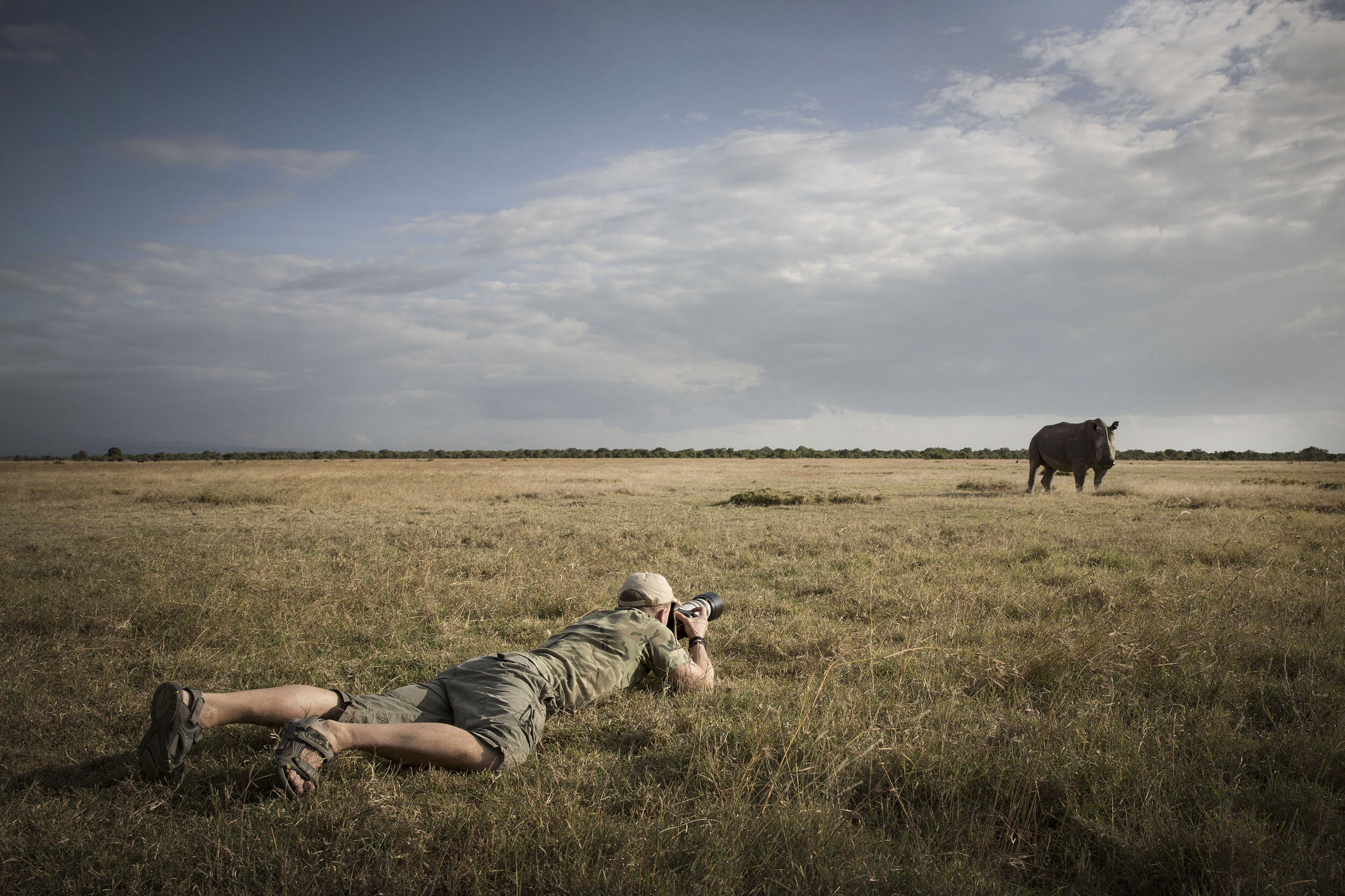 Photographer Bjorn Persson is taking a photo of a rhino in a supplied photo