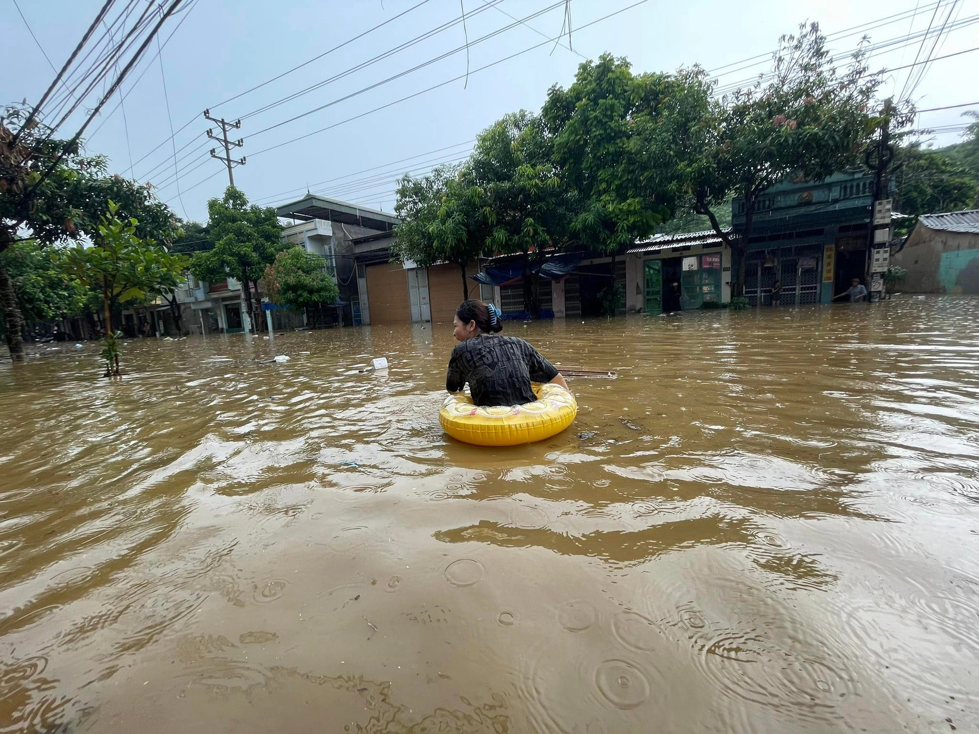 Residents use floaties to commute through waist-high flooding in Vietnam's mountainous region
