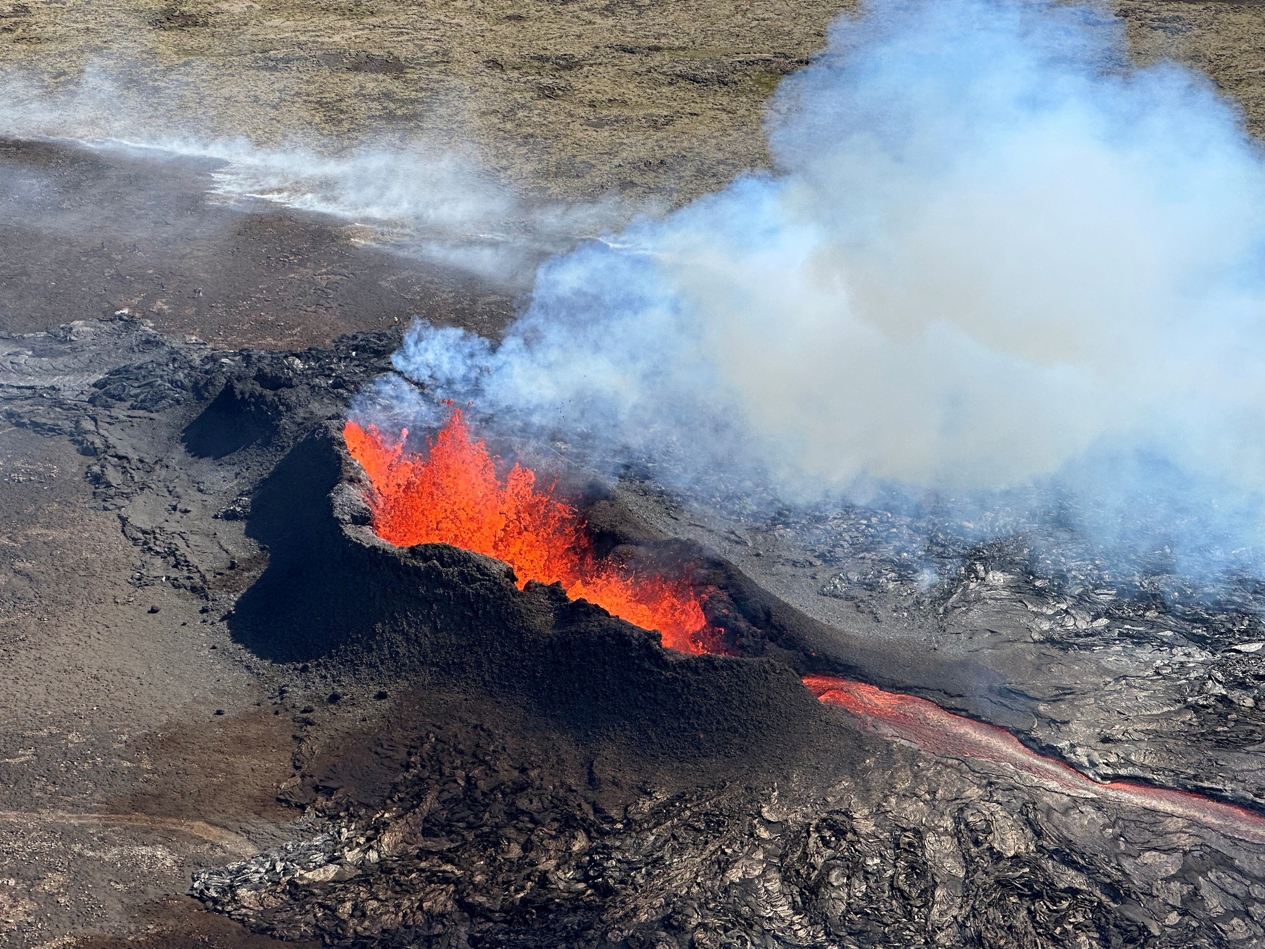 Lava spurts and flows after the eruption of a volcano in the Reykjanes Peninsula, Iceland, July 12, 2023, as seen in this handout picture taken from a Coast Guard helicopter. Photo: Reuters