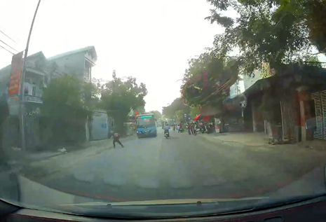 In Vietnam, child risks life by darting in front of bus as joke