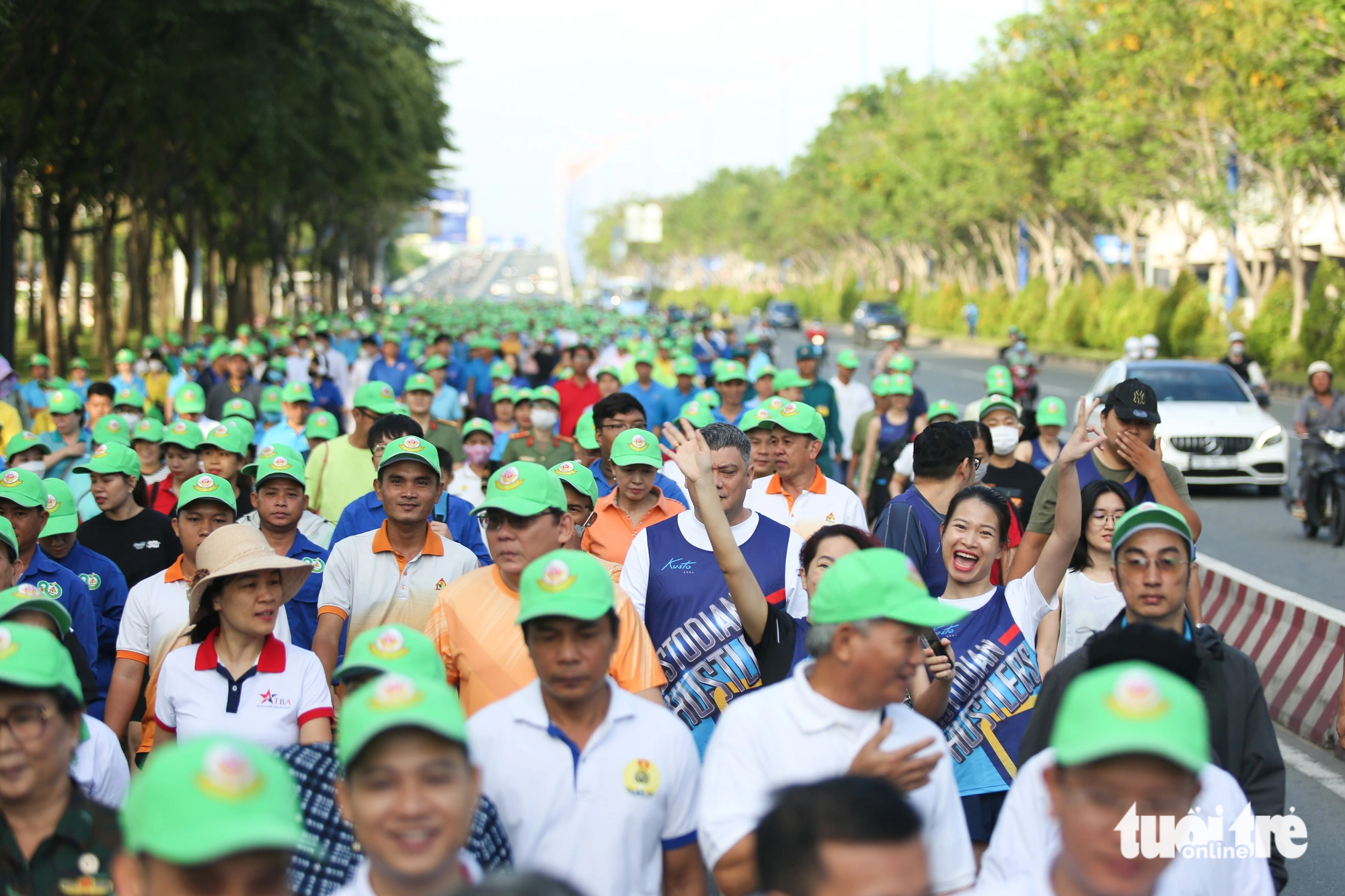 Participants walk along a street near a riverside park in Thao Dien Ward, Thu Duc City