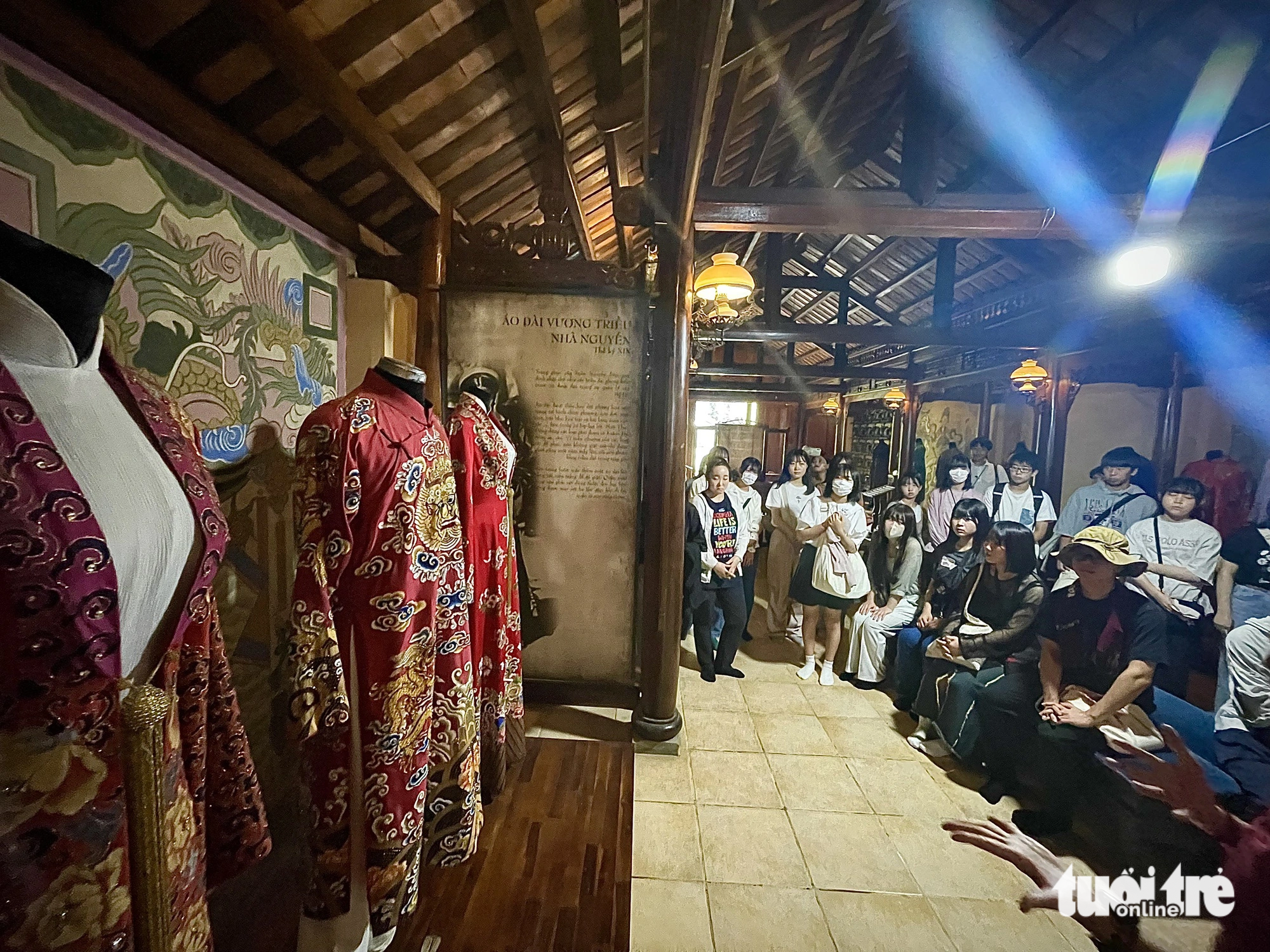 Students of Namiki High School listen to a presentation on the history of ‘ao dai’ during their visit to the Ao Dai Museum in Ho Chi Minh City, November 21, 2023. Photo: Thai Thai / Tuoi Tre