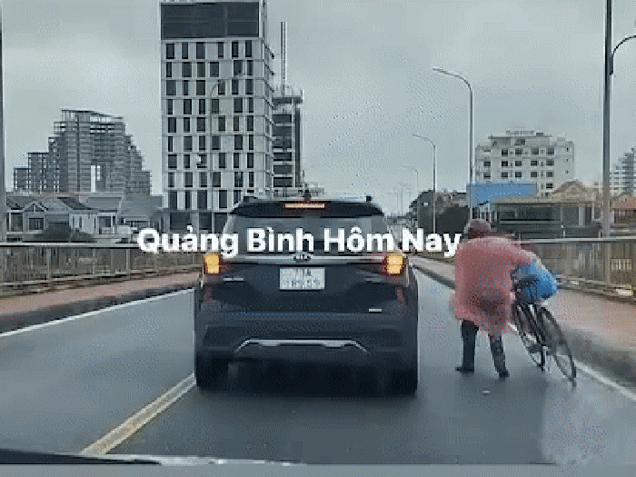 Car shields biker from strong winds in north-central Vietnam