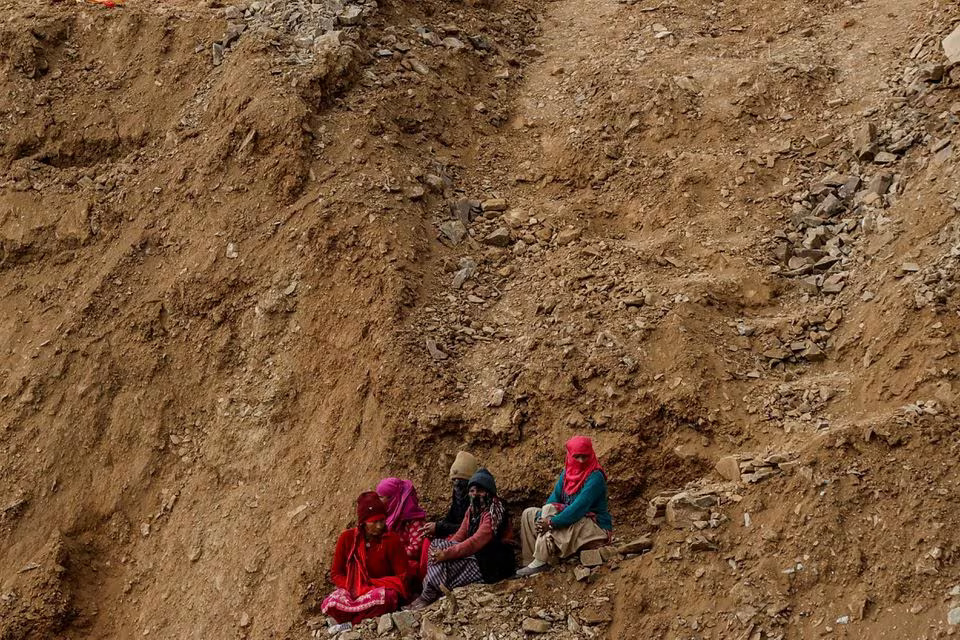 Women watch the rescue operations at a tunnel, where workers are trapped after the tunnel collapsed, from a hillside in Uttarkashi in the northern state of Uttarakhand, India. Photo: Reuters