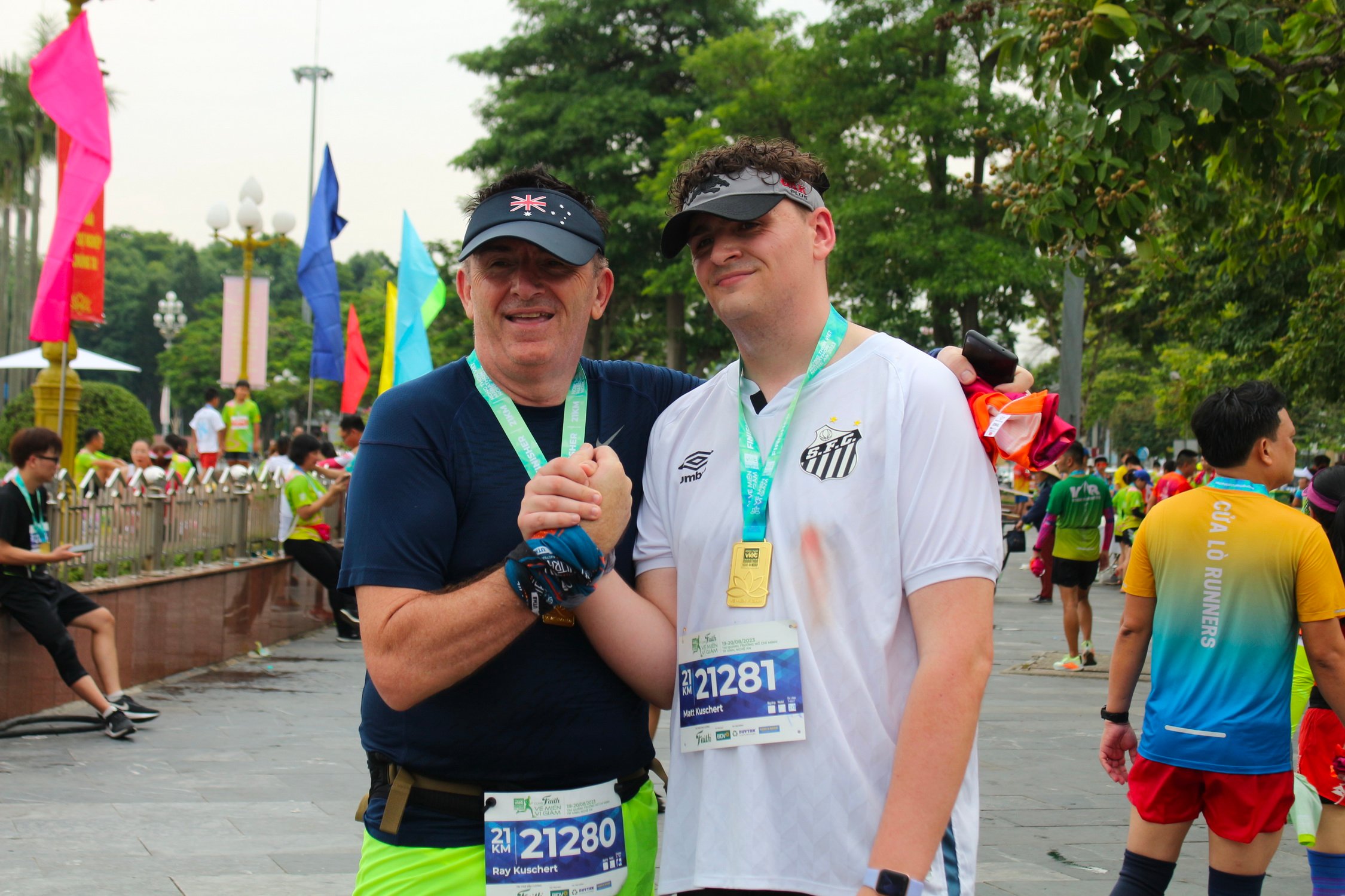 Ray Kuschert (left) and his son Matthew Kuschert pose in this supplied photo after they finished a run in Vinh City, Nghe An Province, Vietnam.
