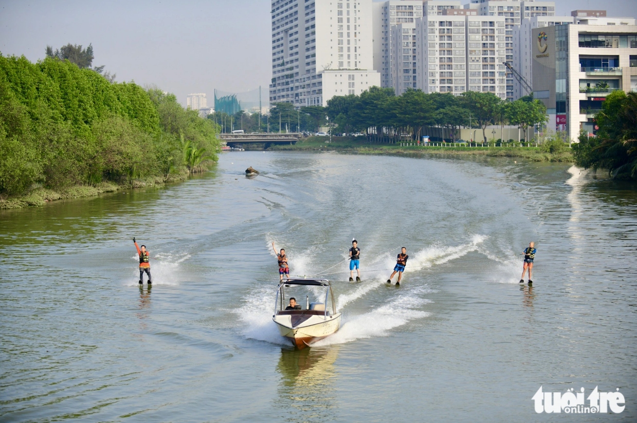 Men are pictured wakeboarding in Ban Nguyet (Crescent) Lake in Ho Chi Minh City. Photo: Quang Dinh / Tuoi Tre