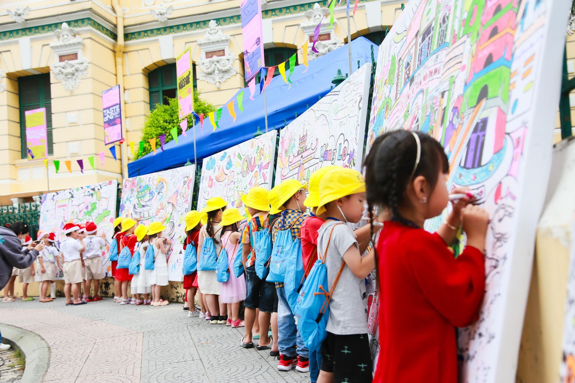 Children contribute to a collaborative painting at the Saigon Urban Street Fest in front of the Saigon Central Post Office in District 1, Ho Chi Minh City, December 8, 2023. Photo: Supplied