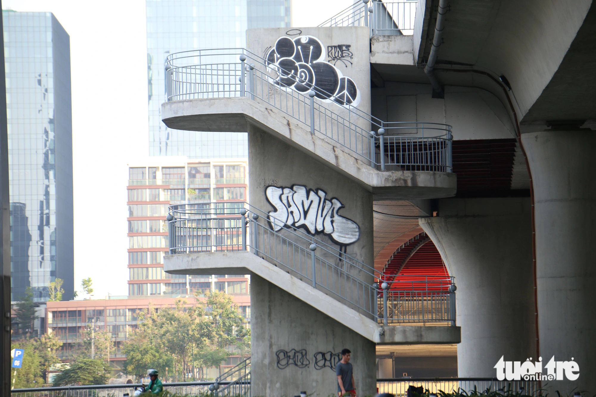 A lower part and a pedestrian stairway of the Ba Son Bridge, also known as Thu Thiem 2 Bridge, in District 1 is seen covered with both old and new graffiti. Photo: Minh Hoa / Tuoi Tre
