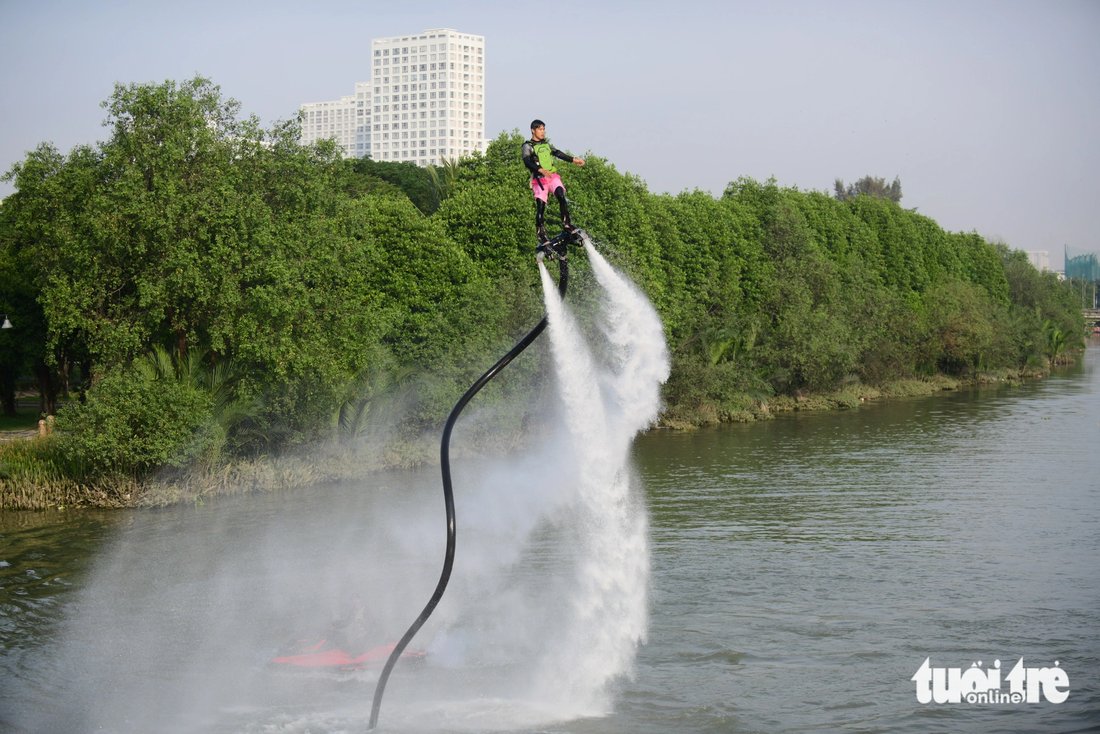 A man performs on a flyboard in a lake in Ho Chi Minh City. Photo: Quang Dinh / Tuoi Tre