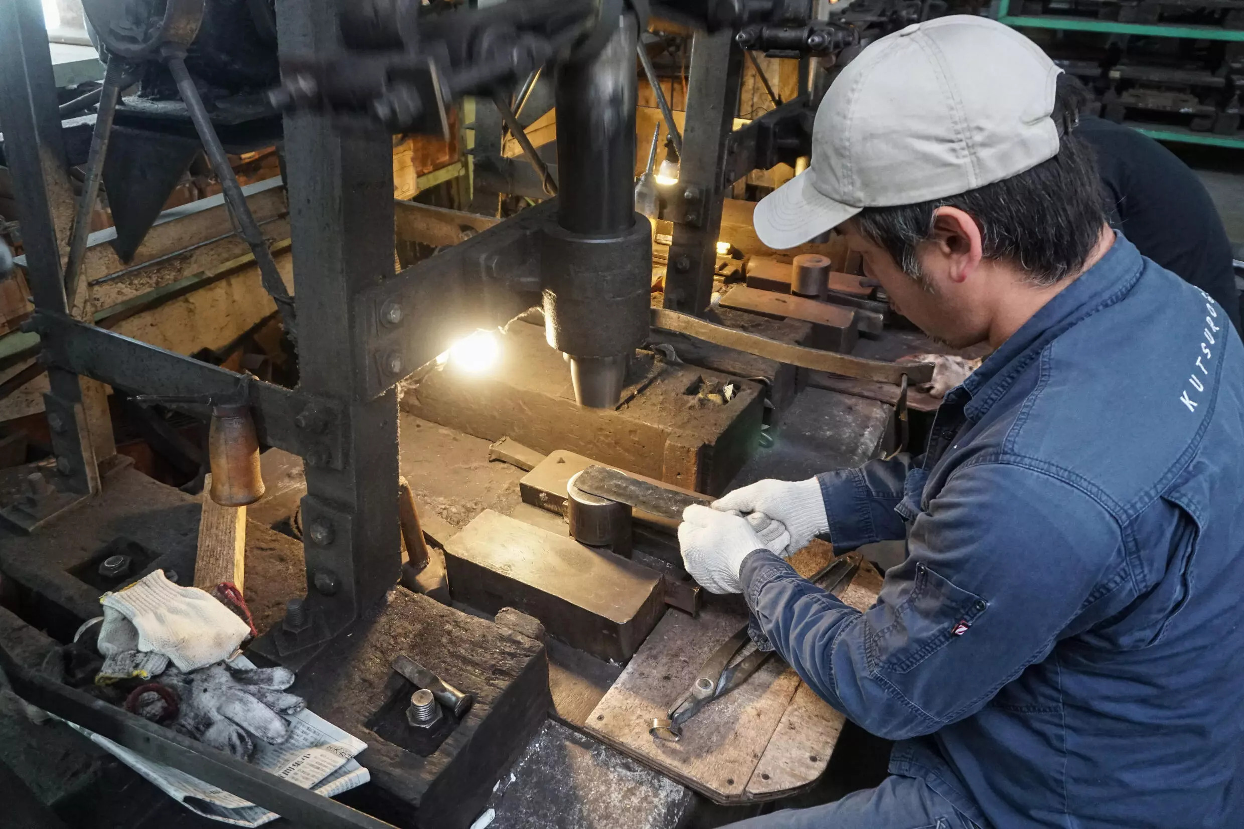 Yoshihiro Yauji places a 'santoku', a multipurpose knife, under a spring hammer, continuing a tradition dating back centuries. Photo: AFP