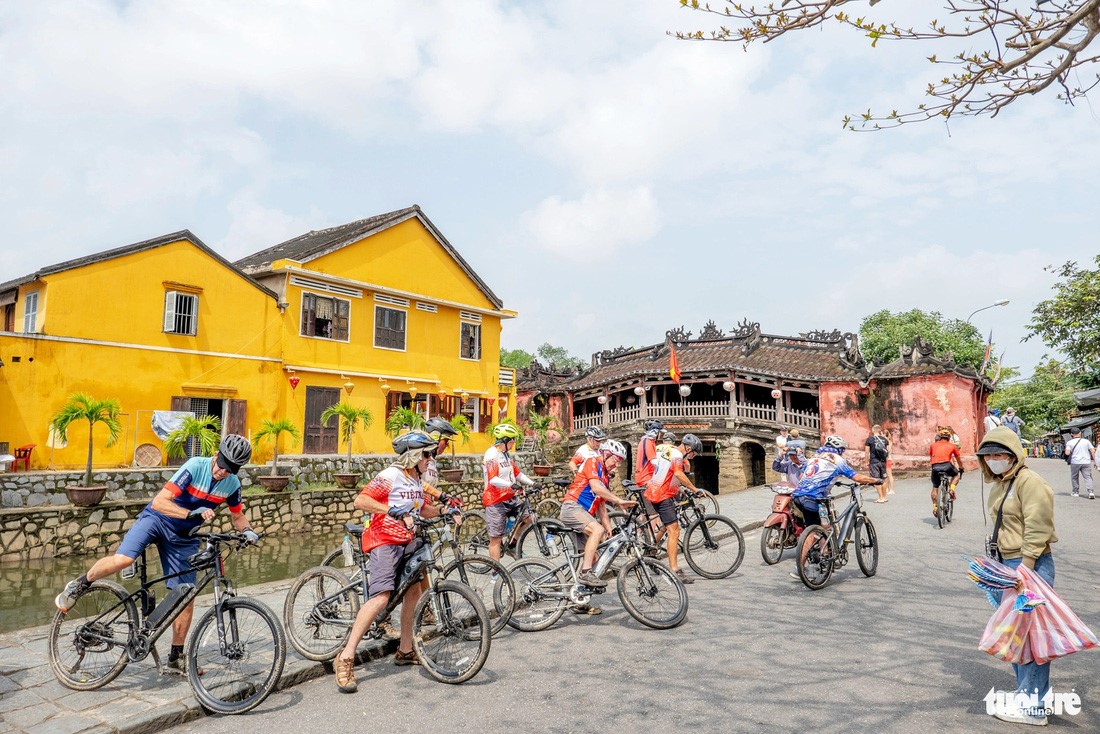 Australian tourists return to Vietnam to explore the Hoi An Ancient Town in the namesake city in Quang Nam Province, central Vietnam by bicycle.