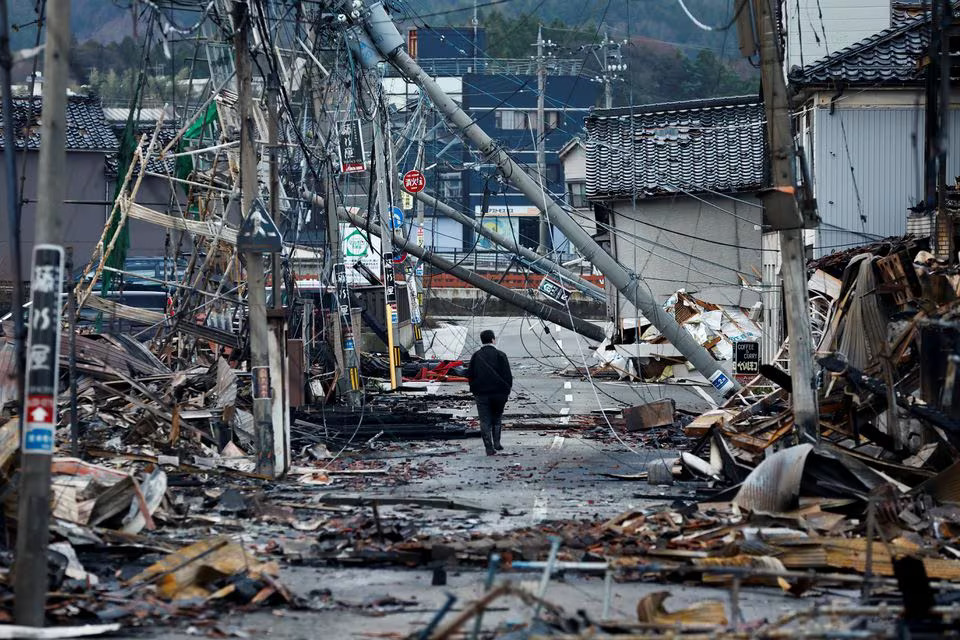 A man makes his way along Asaichi-dori street, which burned down due to a fire following an earthquake, in Wajima, Japan, January 4, 2024. Photo: Reuters