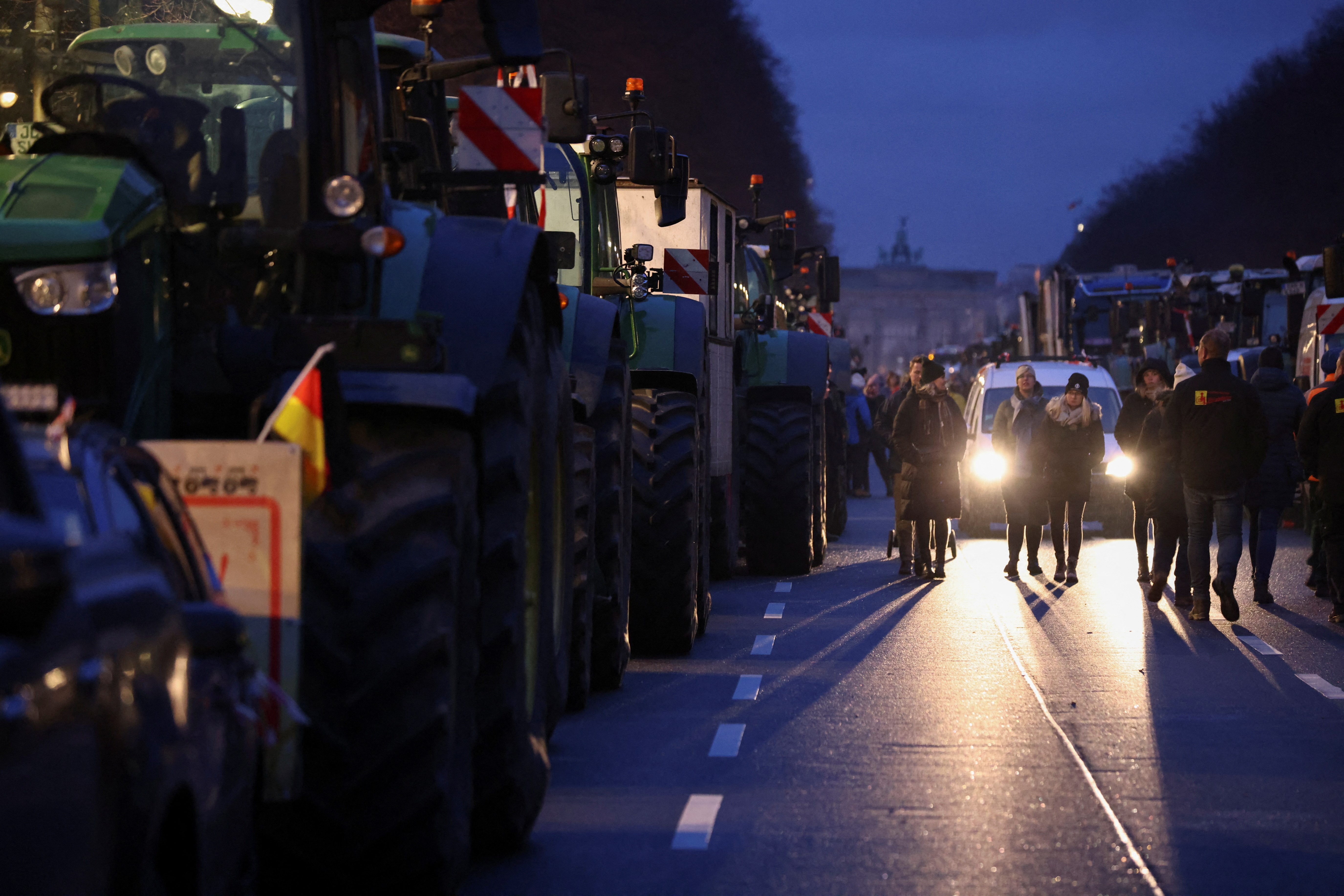 German farmers line up their tractors at the Strasse des 17. Juni in front of the Brandenburg Gate to prepare one day before a large protest against the cut of farm vehicle tax subsidies of the so-called German Ampel coalition government, in Berlin, Germany, January 14, 2024. Photo: Reuters