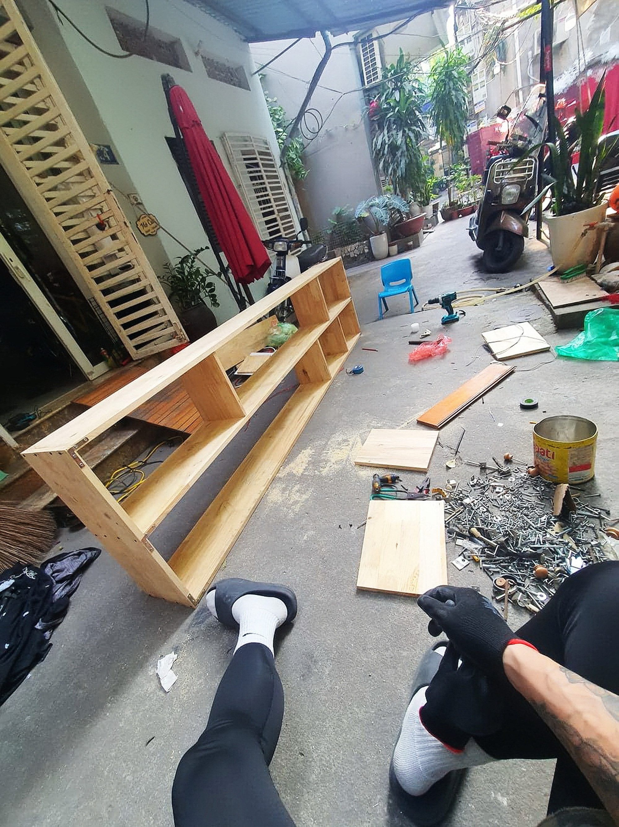 Tran Thuy’s husband builds a bookshelf for their son in Hanoi. Photo: Supplied