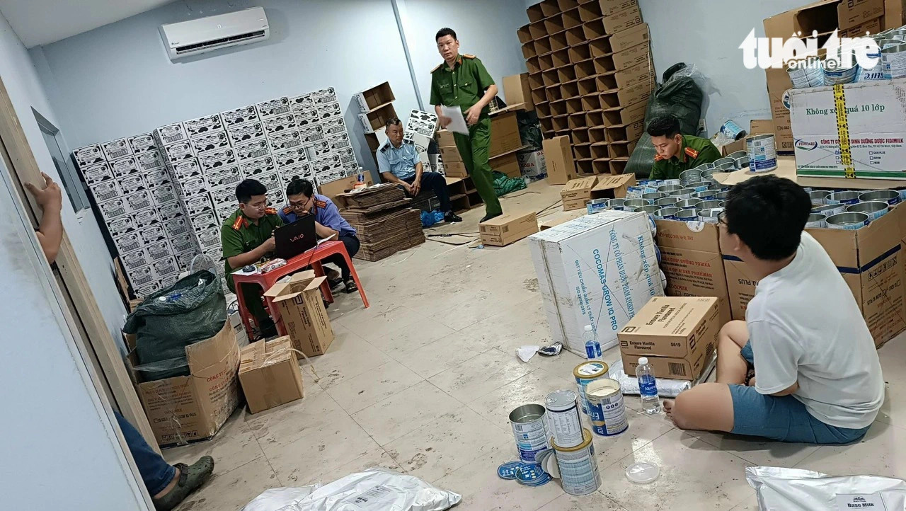 Police officers raid a business facility making probable adulterated milk powder. Photo: Supplied