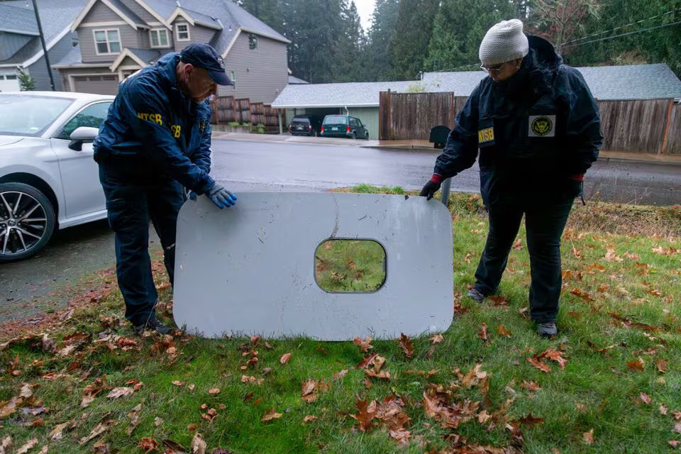 National Transportation Safety Board (NTSB) investigators examine the fuselage plug area of Alaska Airlines Flight 1282 Boeing 737-9 MAX, which was jettisoned and forced the aircraft to make an emergency landing, at a property where it was recovered in Portland, Oregon, U.S. January 8, 2024. Photo: Reuters