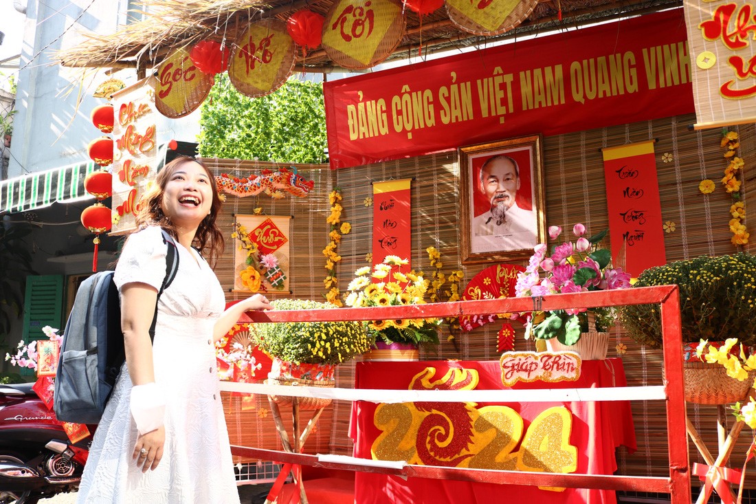 Le Thi My Hang, a 36-year-old resident in Ho Chi Minh City, is excited as the alley where she is living is decorated beautifully. Photo: Be Hieu / Tuoi Tre