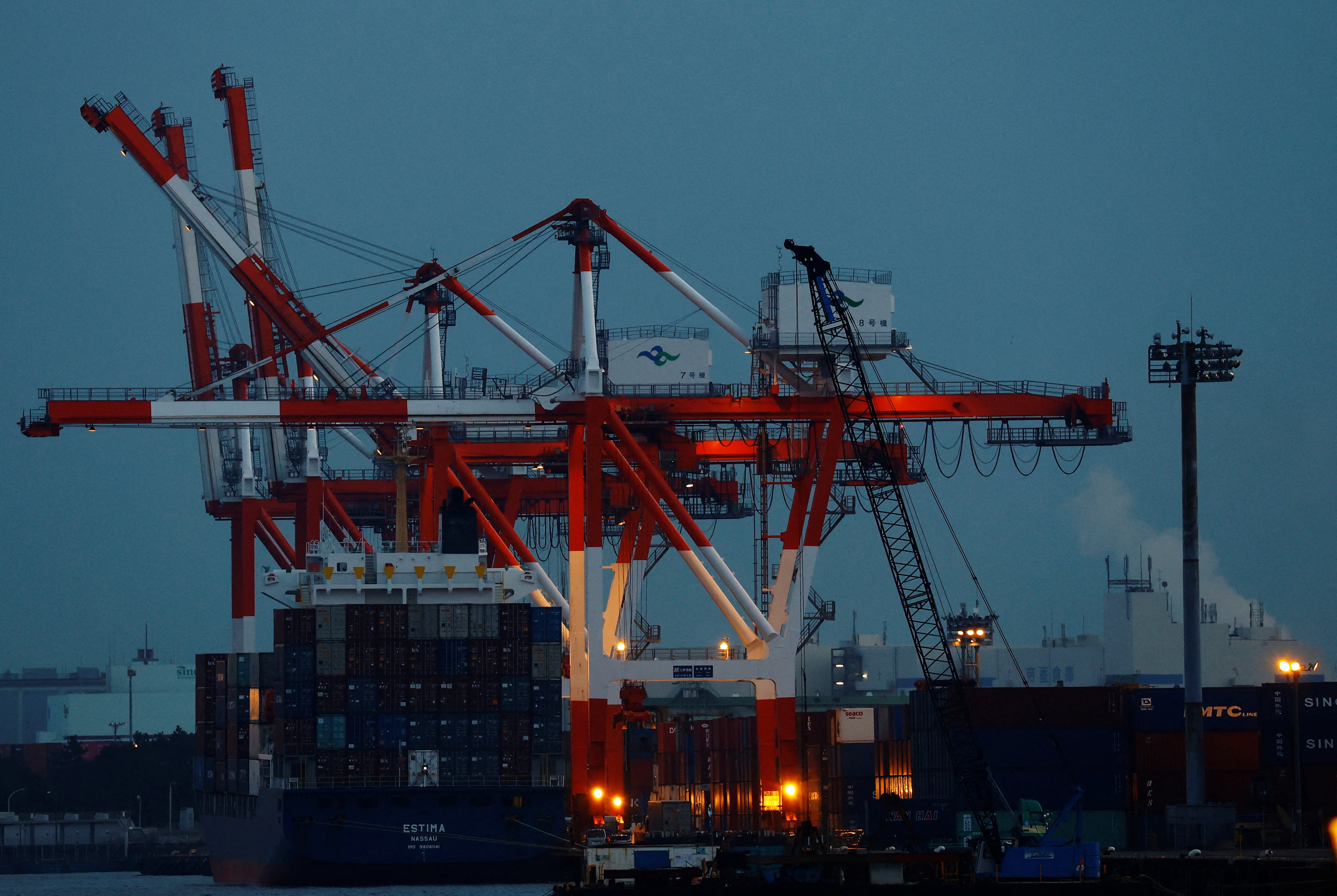 A cargo ship and containers are seen at an industrial port in Tokyo, Japan, February 15, 2022. Photo: Reuters