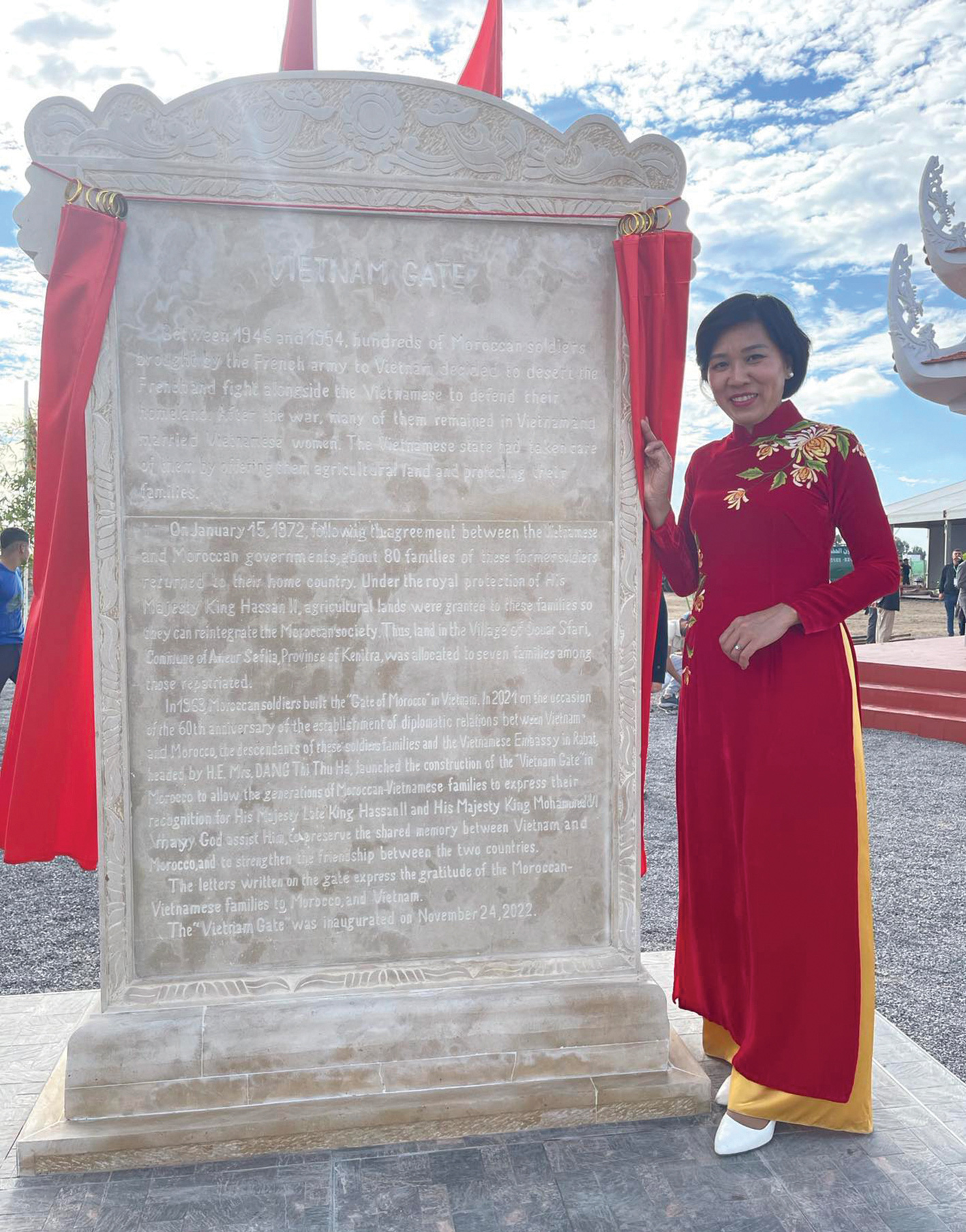 Vietnamese Ambassador to Morocco Dang Thi Thu Ha poses next to the stele explaining the story of the Vietnam gate in Morocco. Photo: Supplied