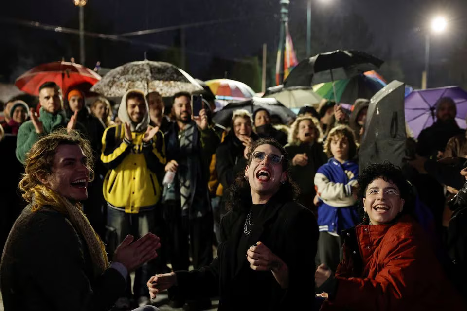 Members of the LGBTQ+ community and supporters watch the end of debate in front of the Greek parliament, ahead of the vote on the bill which legalises same-sex civil marriage, in Athens, Greece, February 15, 2024. Photo: Reuters