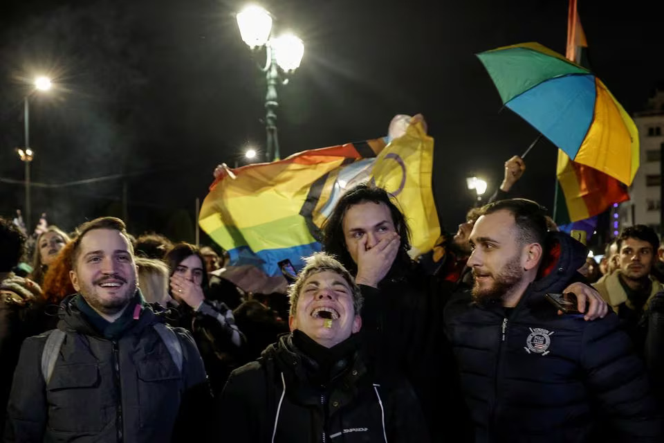 Members of the LGBTQ+ community and supporters celebrate in front of the Greek parliament, after the vote in favour of a bill which approved allowing same-sex civil marriages, in Athens, Greece, February 15, 2024. Photo: Reuters
