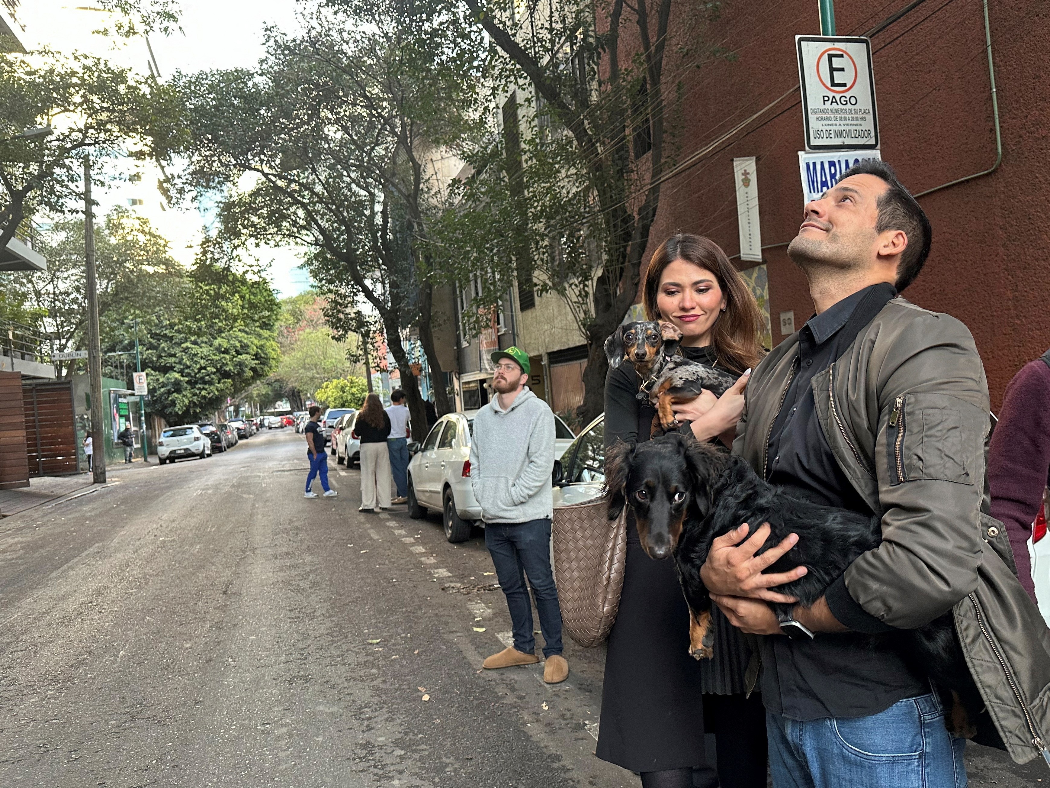 People wait outside their homes and buildings after an alarm sounded warning of a tremor, in Mexico City, Mexico, February 17, 2024. Photo: Reuters