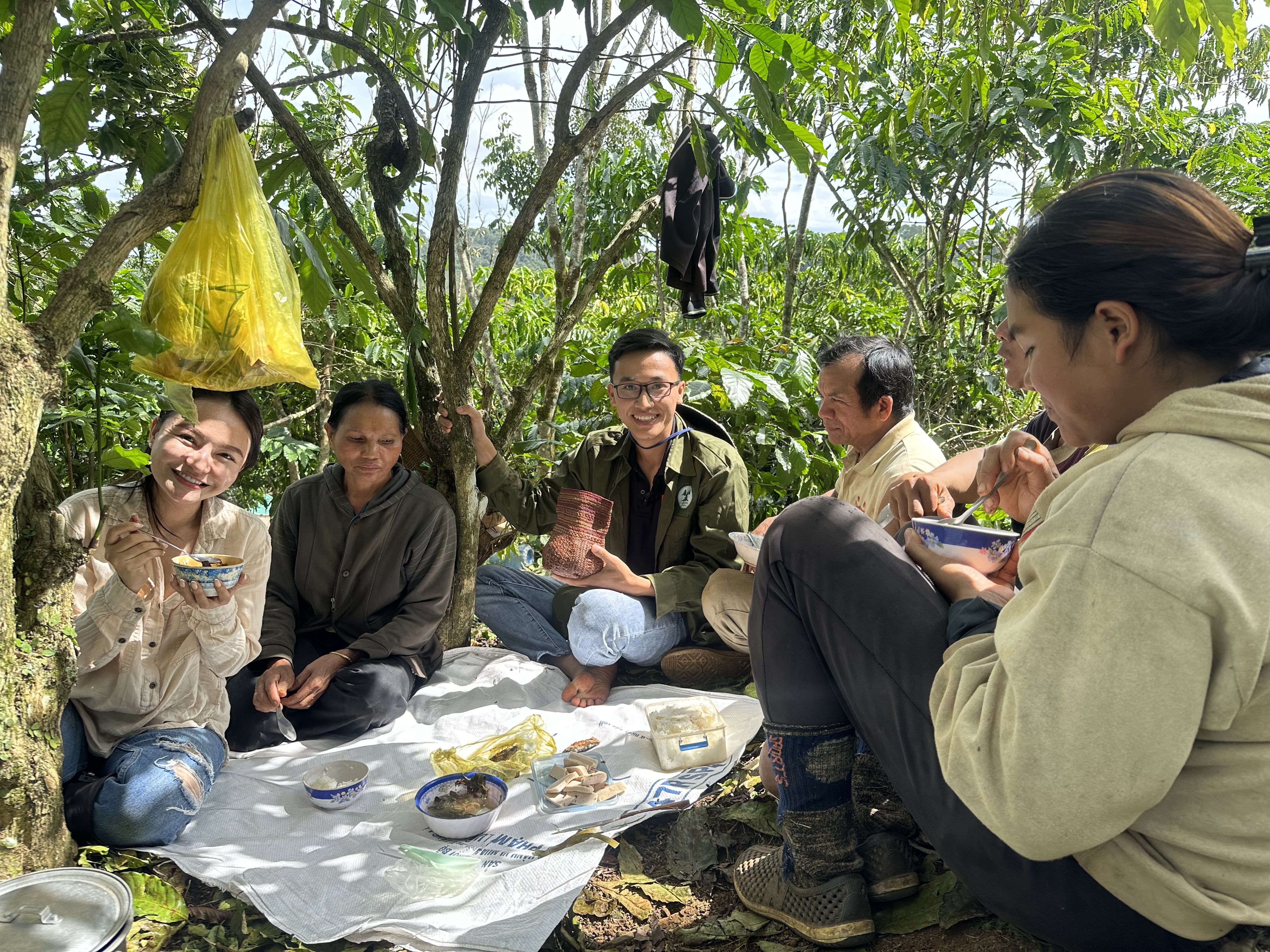 In this supplied photo, Dao Thuy Linh (first from left) joins a meal with Ma people on at a coffee farm in Loc Lam Commune, Bao Lam District, Central Highlands Province of Lam Dong November 2023.