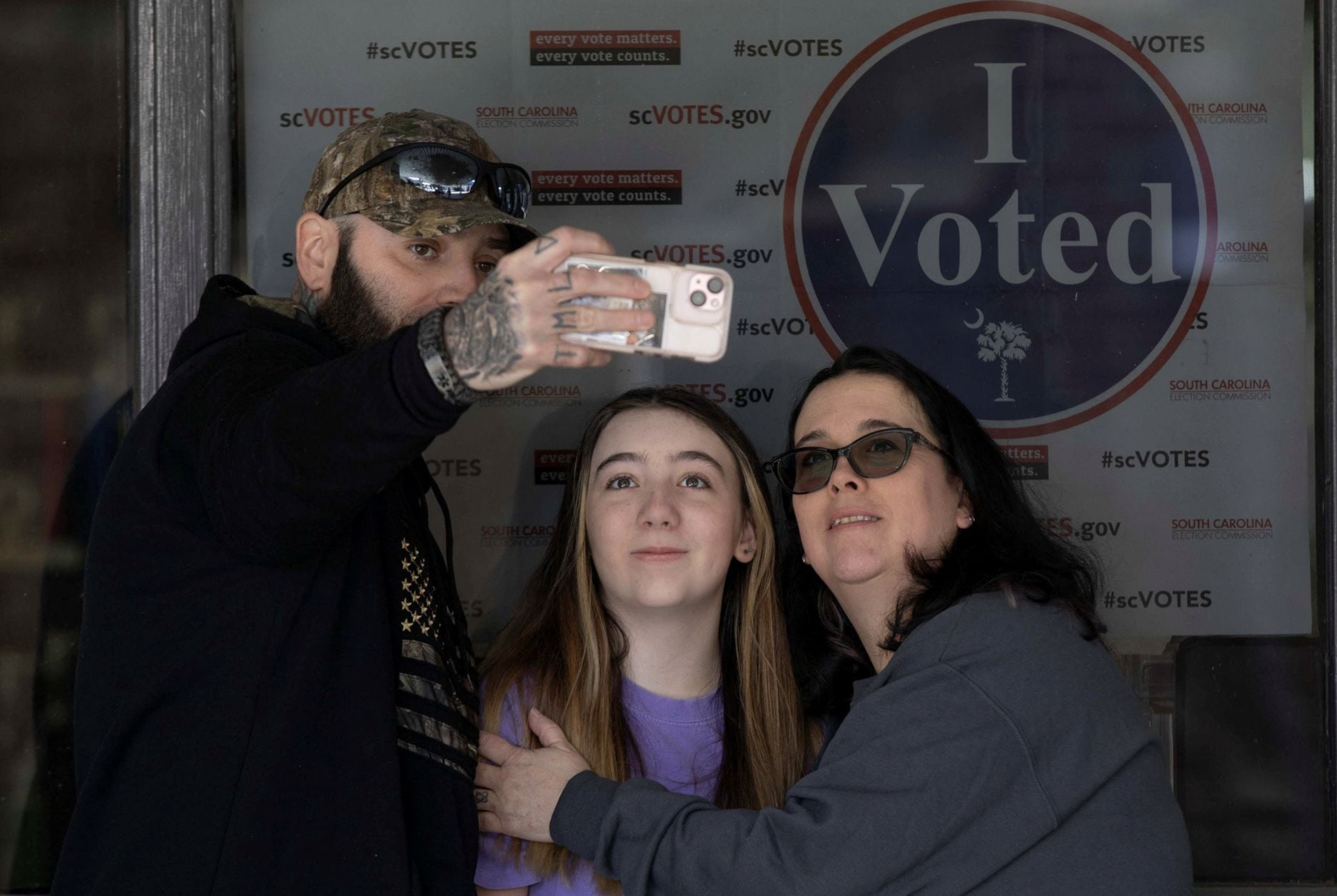 Devon, Serenity and Wendy Hoyt take a selfie after voting at Pelion Elementary School during the Republican presidential primary election on election day in Pelion, South Carolina, U.S. February 24, 2024. Photo: Reuters