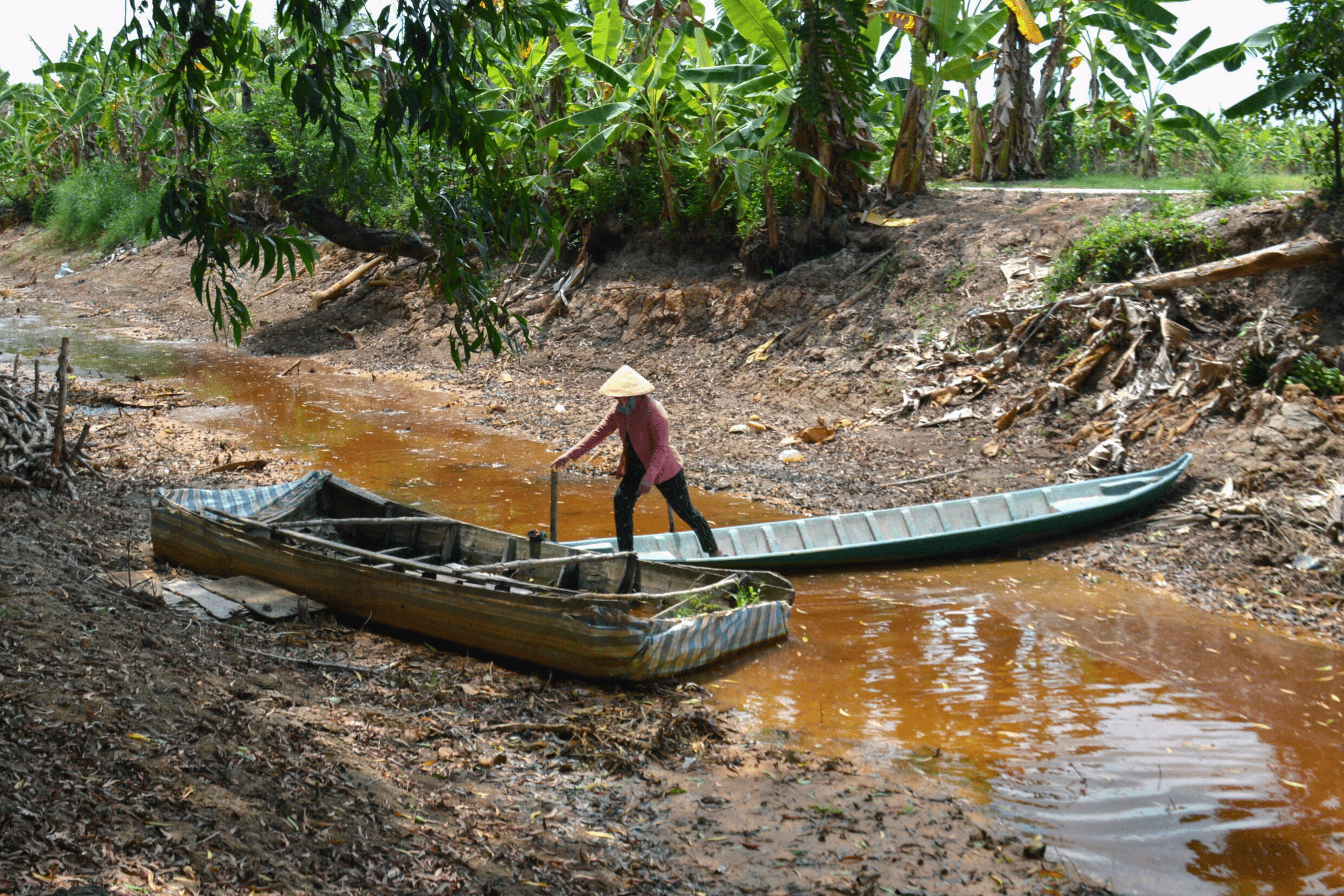 A farmer crosses an almost completely dried-up canal in southern Vietnam's Ca Mau Province, which suffered a prolonged heatwave in February. Photo: AFP