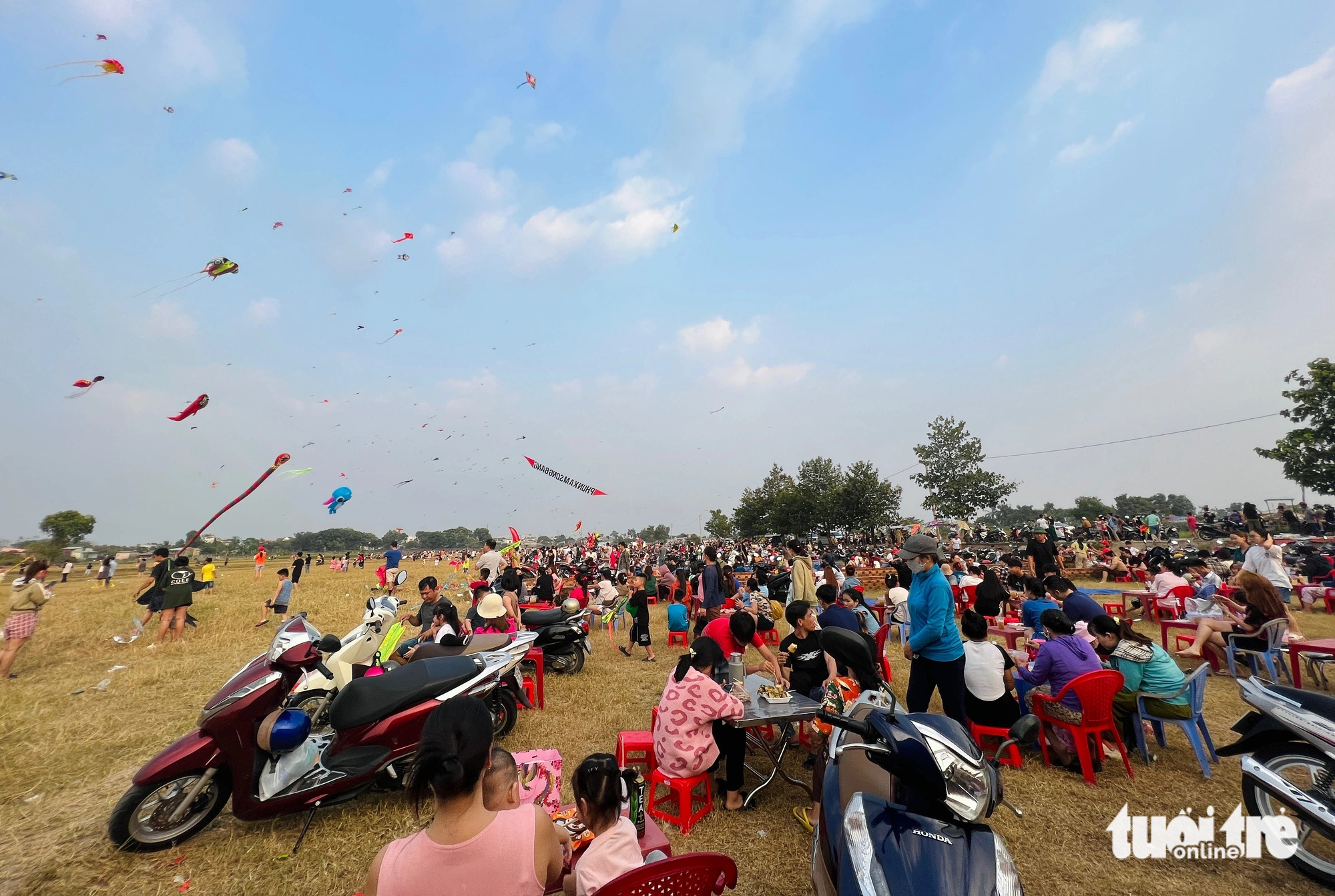 People gather to fly kites at a field along Nguyen Thi Danh Road in the suburban district of Hoc Mon, Ho Chi Minh City. Photo: Yen Trinh / Tuoi Tre