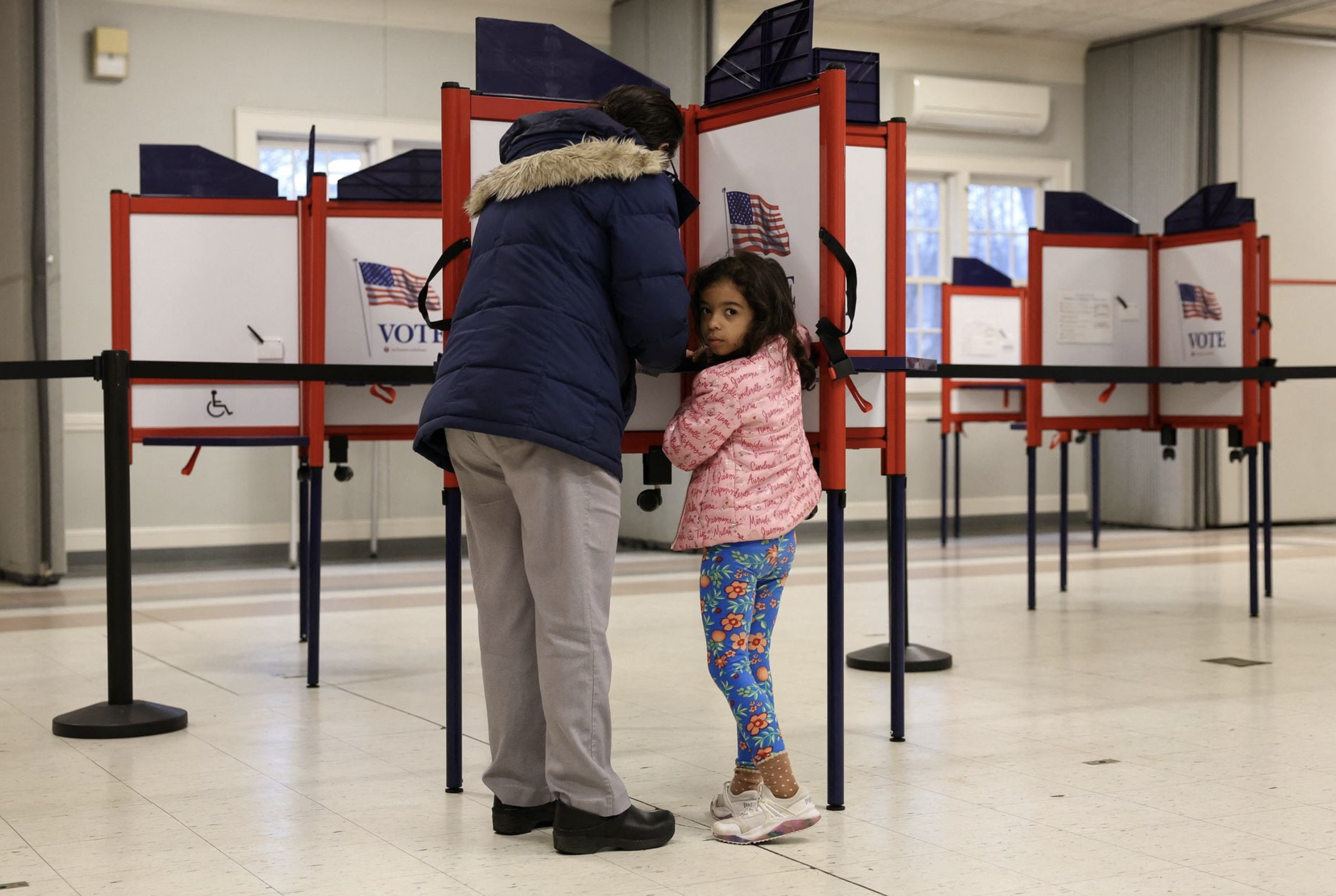 Sophie Townes, 5, looks on as her mother Katie votes during the Super Tuesday primary election, in Topsfield, Massachusetts, U.S., March 5, 2024. Photo: Reuters