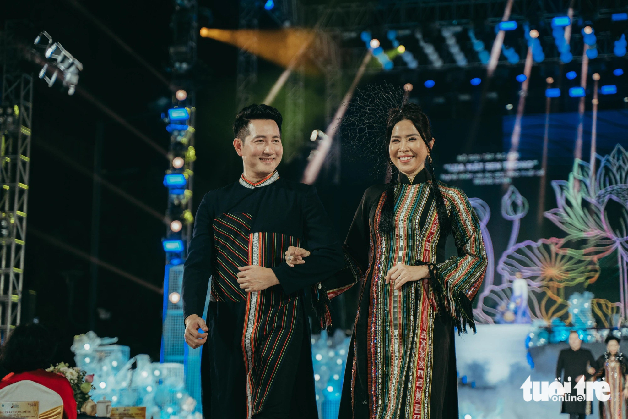 Singer Nguyen Phi Hung (L) and TV presenter Quynh Hoa showcase new ‘ao dai’ designs during the opening night of the 2024 Ho Chi Minh City Ao Dai Festival, March 7, 2024. Photo: Thanh Hiep / Tuoi Tre