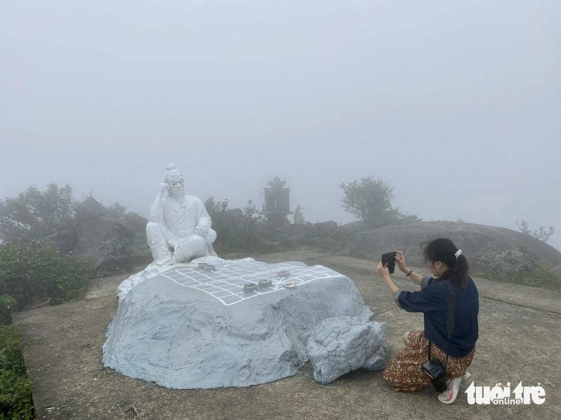 Stone sculpture of a fairy eternally deep in thought over a losing game of chess lies on top of Ban Co Peak on the Son Tra Peninsula, Da Nang City, central Vietnam. Photo: Truong Trung / Tuoi Tre