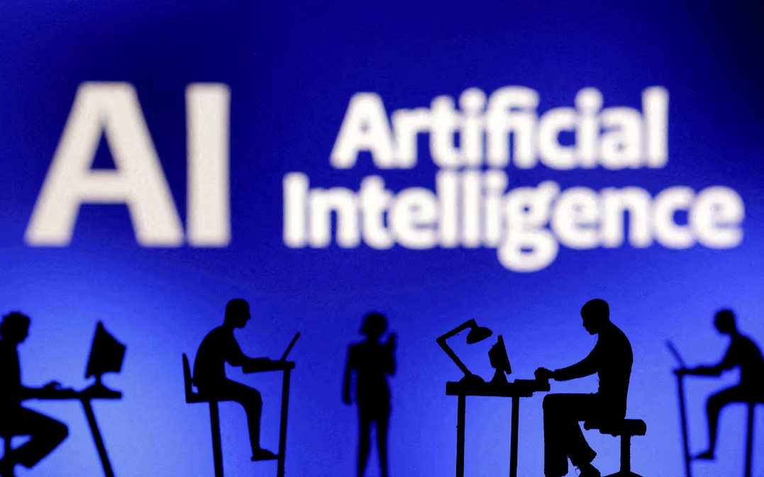 Figurines with computers and smartphones are seen in front of the words 'Artificial Intelligence AI' in this illustration taken, February 19, 2024. Photo: Reuters