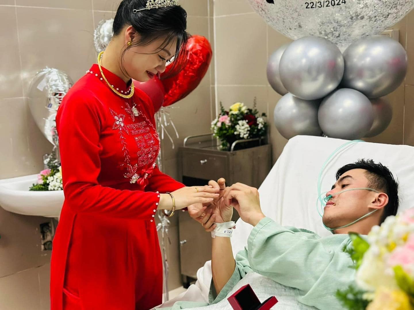 T.H. places a wedding ring on N.A.'s finger during their hospital bedside wedding at Lang Son General Hospital in Lang Son Province, northern Vietnam, March 22, 2024. Photo: Supplied