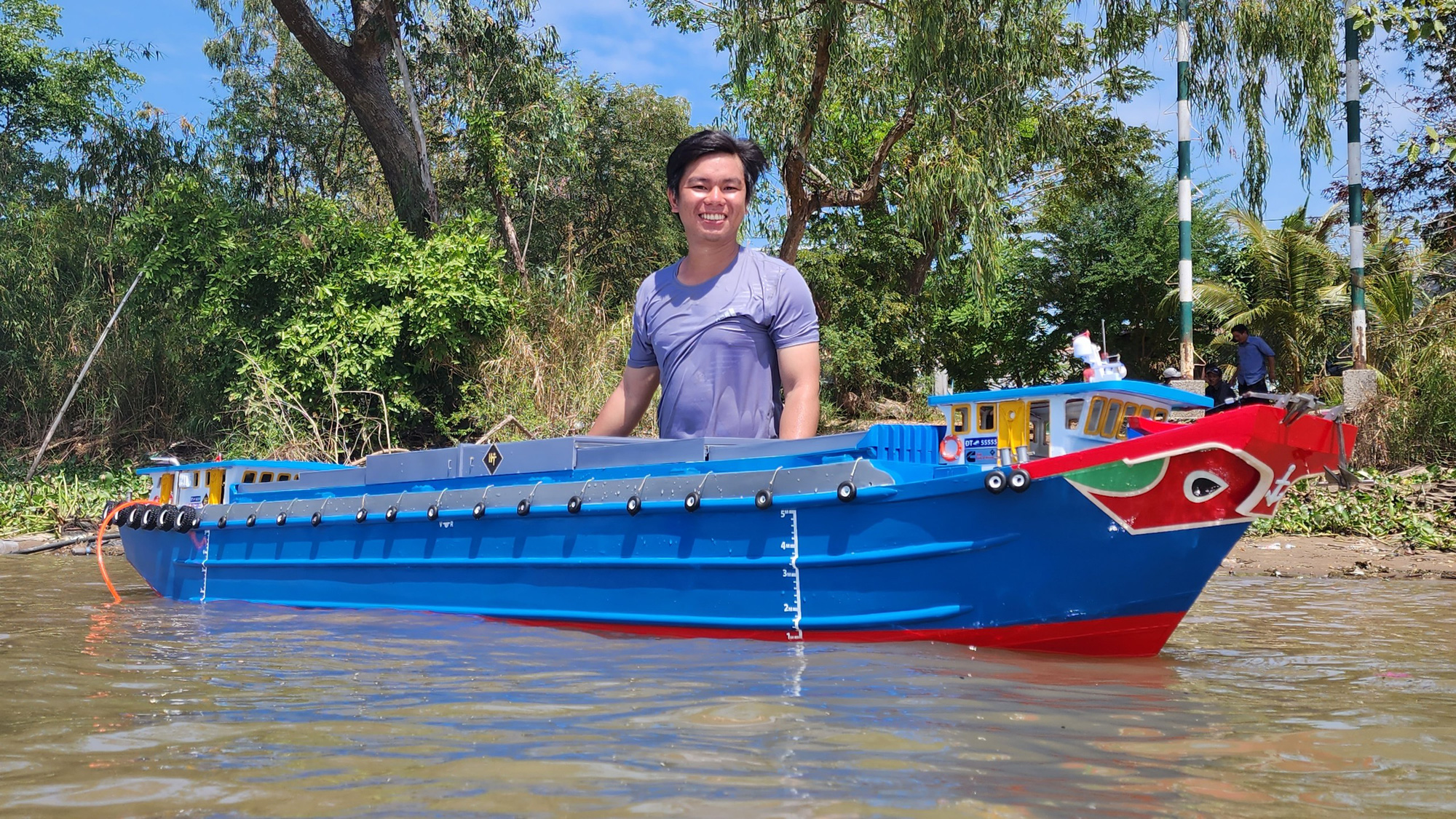 Mai Hoang Thanh showcases a boat model in Hon Dat District, Kien Giang Province, southern Vietnam. Photo: Hoang Thanh / Tuoi Tre