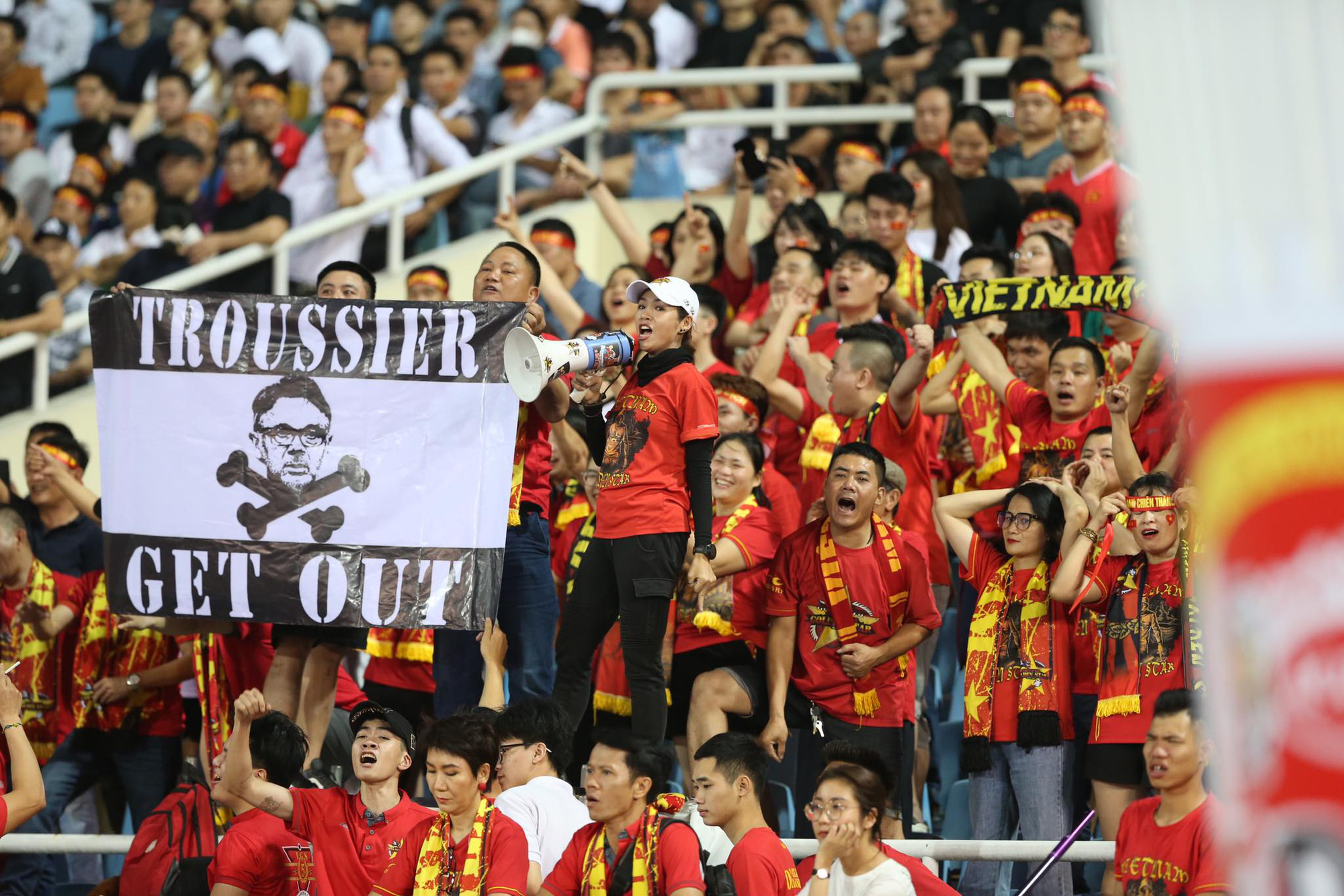 A Vietnamese supporter holds a ‘TROUSSIER GET OUT' sign during the Vietnam-Indonesia match at My Dinh National Stadium in Hanoi, March 26, 2024. Photo: Hoang Tung / Tuoi Tre