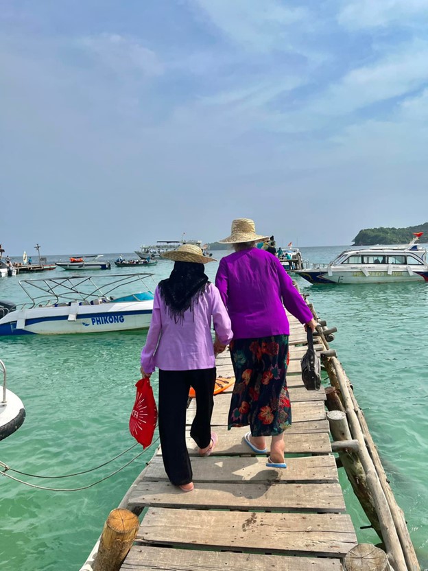 Two of the three hold hands to reach a speedboat on Phu Quoc. Photo: Supplied