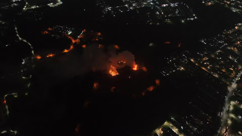 A drone view shows smoke and flames rising out of a military ammunition facility in Ciangsana, Bogor, Indonesia, March 30, 2024, in this screengrab obtained from a social media video. Fritz Markus via Reuters