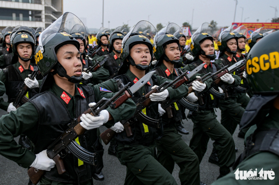 Rehearsed Vietnamese police parade a feast for the eyes
