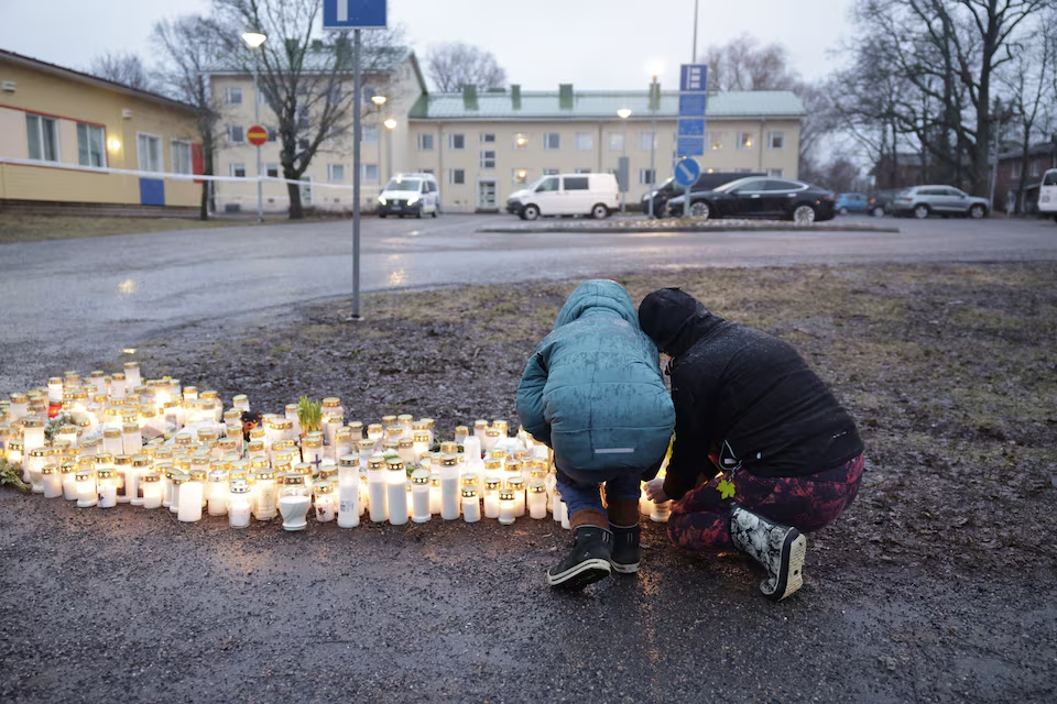 People bring candles and flowers at the Viertola school in Vantaa, Finland, on April 2, 2024. One sixth grade pupil died and two others were seriously injured in a shooting incident at the school on Tuesday morning. The suspect is also a 12-year-old pupil at the school. Lehtikuva/Roni Rekomaa via Reuters