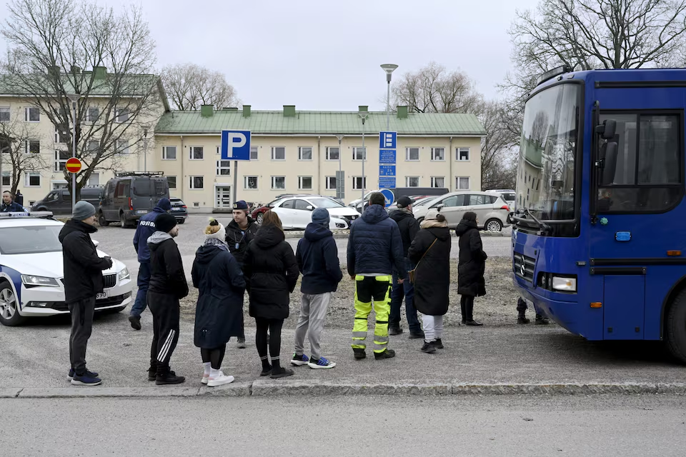 Police officers talk to family members of pupils at the Viertola comprehensive school in Vantaa, Finland, on April 2, 2024. Lehtikuva/Markku Ulander via Reuters
