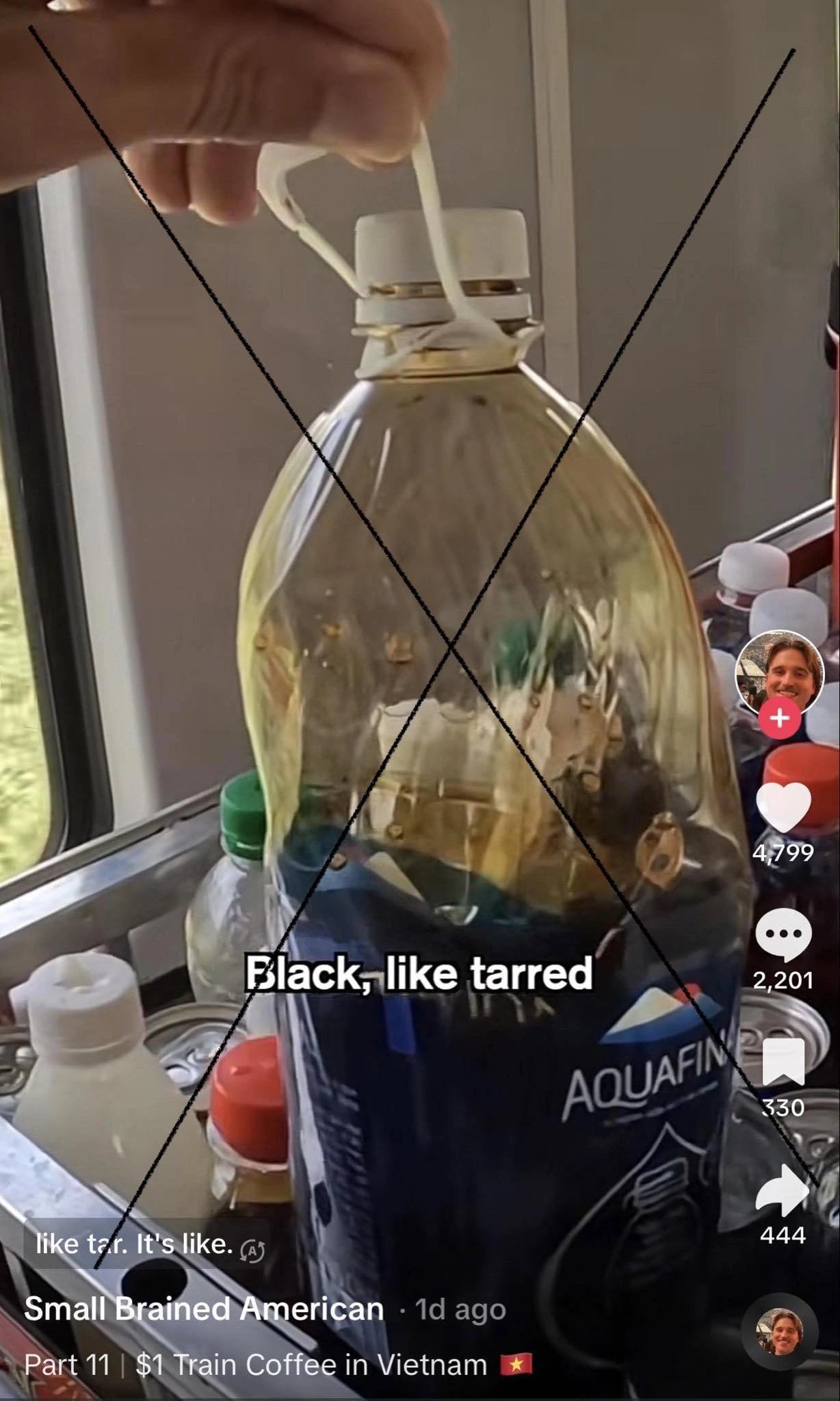 A screen shot from a video of Small Brained American shows a bottle of black coffee on a Vietnam's train that was said to be 'black like tarred'.
