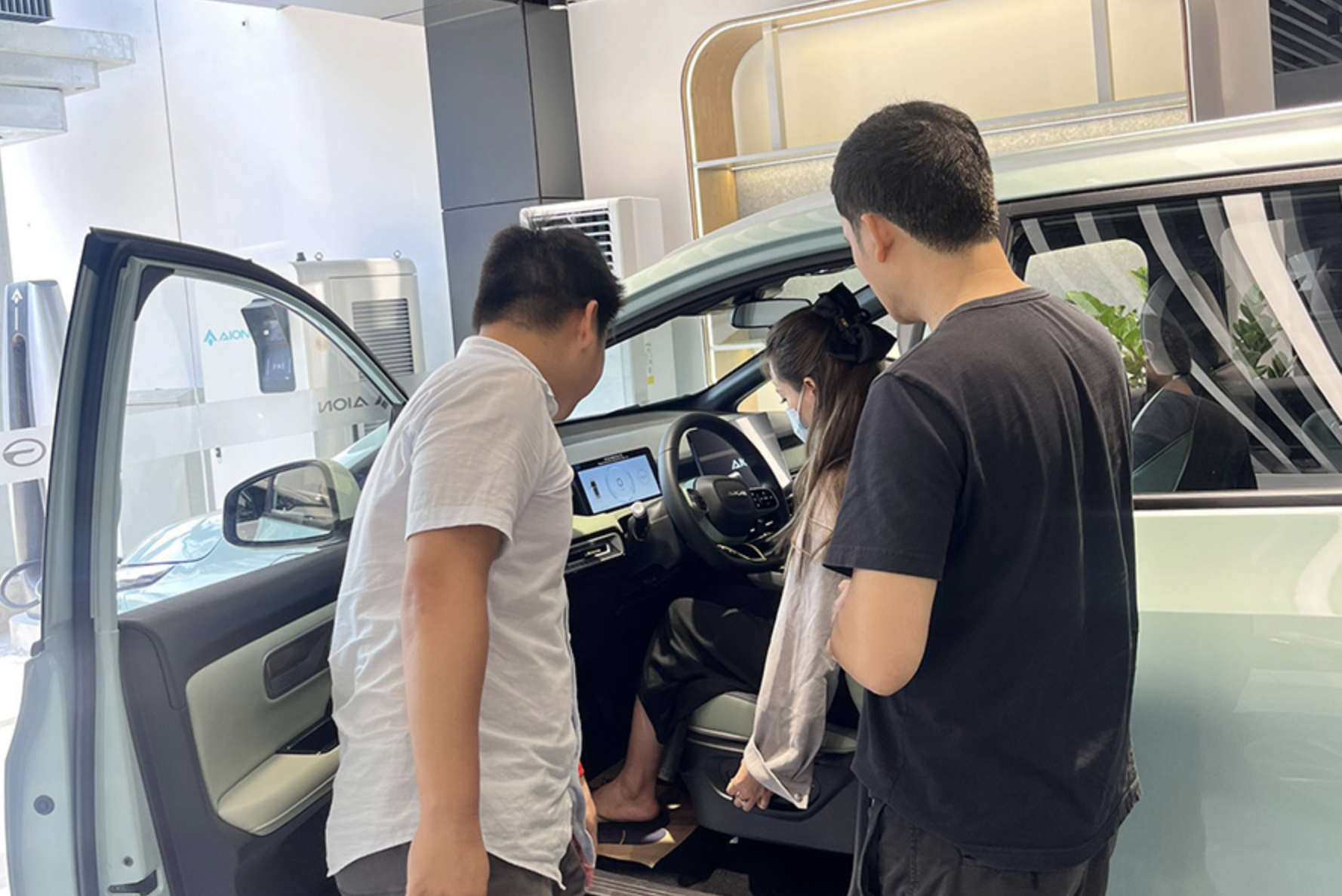 Customers take a look at an Aion car on display at a showroom in Ho Chi Minh City. Photo: AION Vietnam