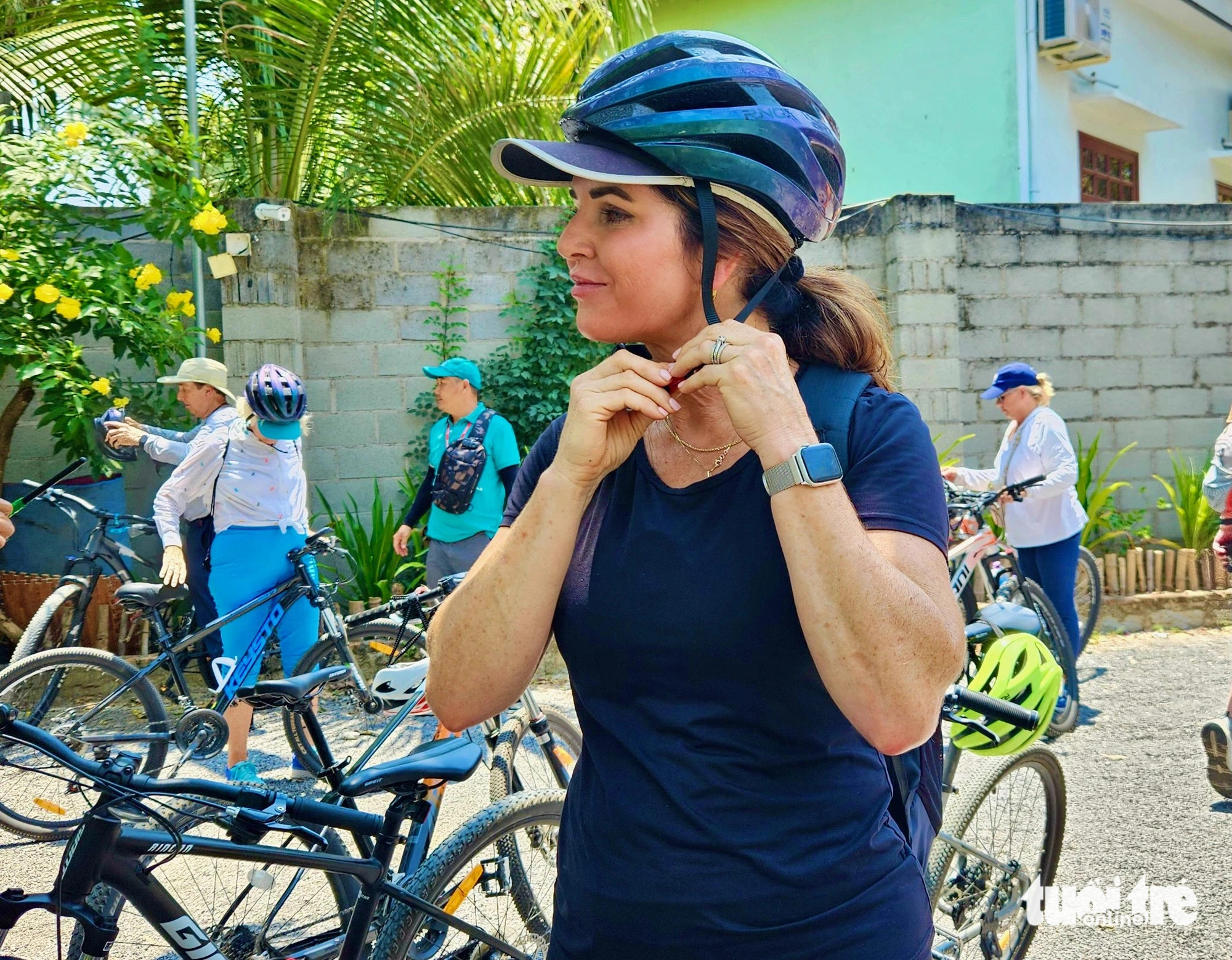 Lee Kreps, an American tourist, puts on a helmet before starting her bicycle tour of the countryside in Nha Trang City, Khanh Hoa Province, south-central Vietnam. Photo: Minh Chien / Tuoi Tre