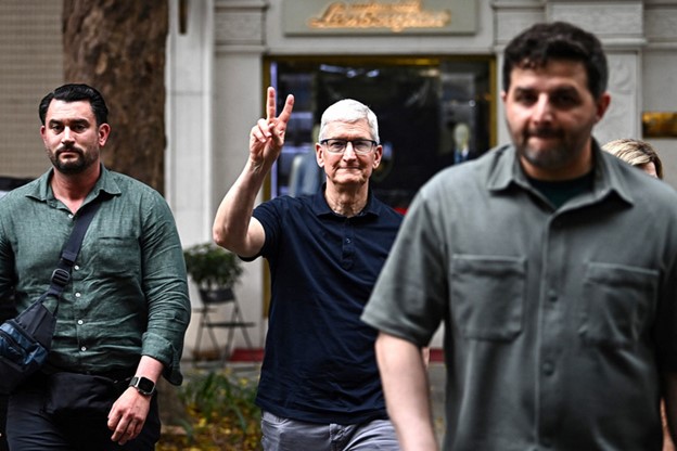 Tim Cook makes a hand gesture to greet people in Hanoi on April 15, 2024. Photo: AFP